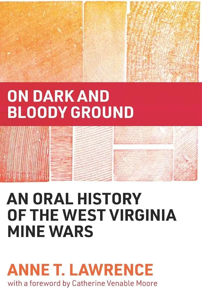 Book cover titled "On Dark and Bloody Ground" with subtitle "An Oral History of the West Virginia Mine Wars" by Anne T. Lawrence, featuring textured backgrounds in shades of orange and red.