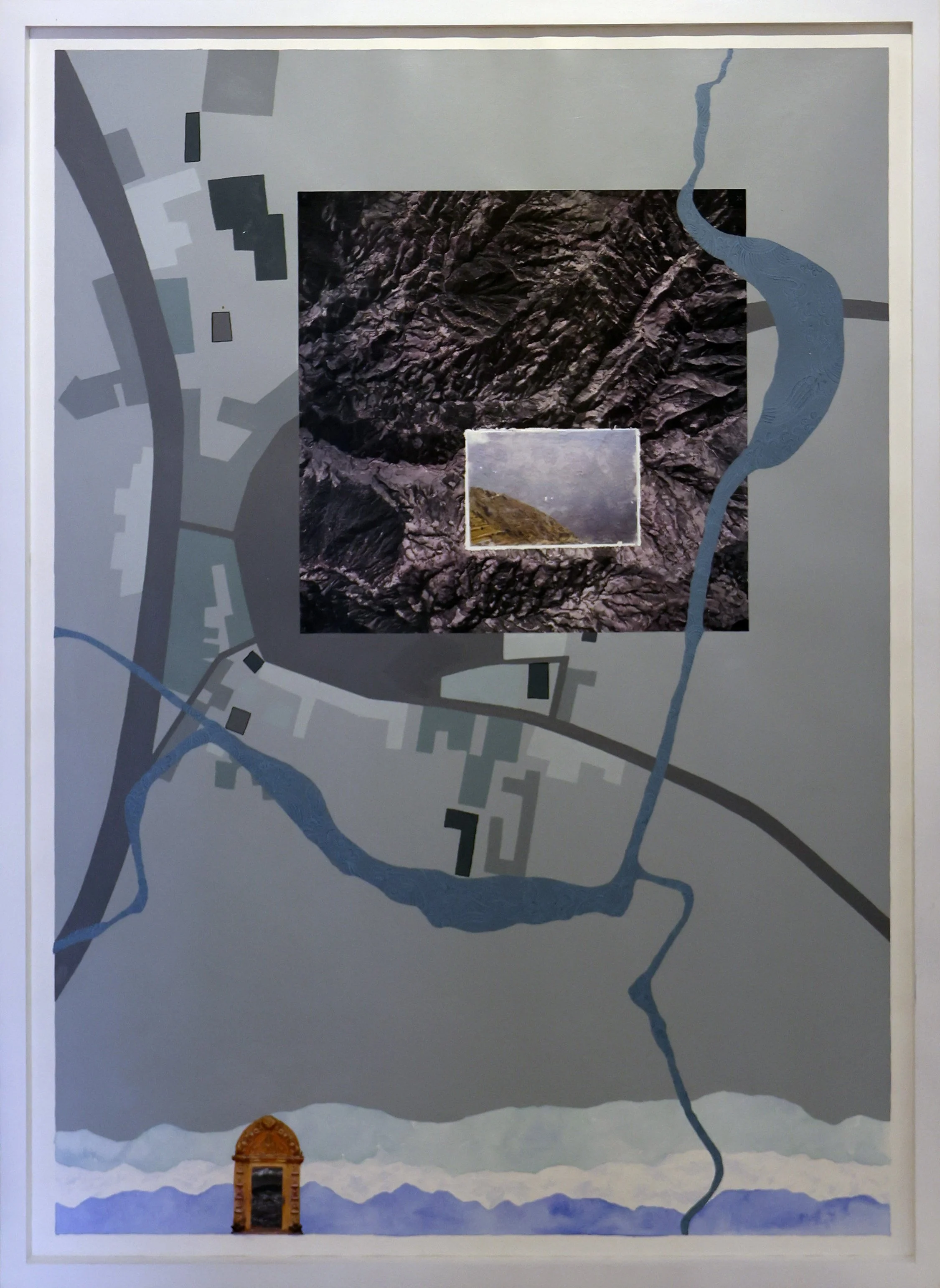 Map of a landscape showing a river running through mountains, with a small image of rocky terrain in the center. There is a structure at the bottom left of the map, resembling a small monument or arch. The map has various colored and shaded areas ind