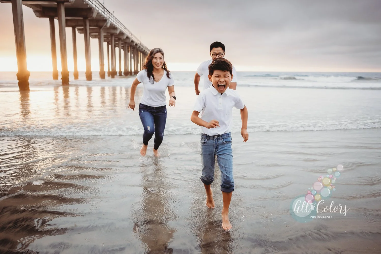 small family running at the beach