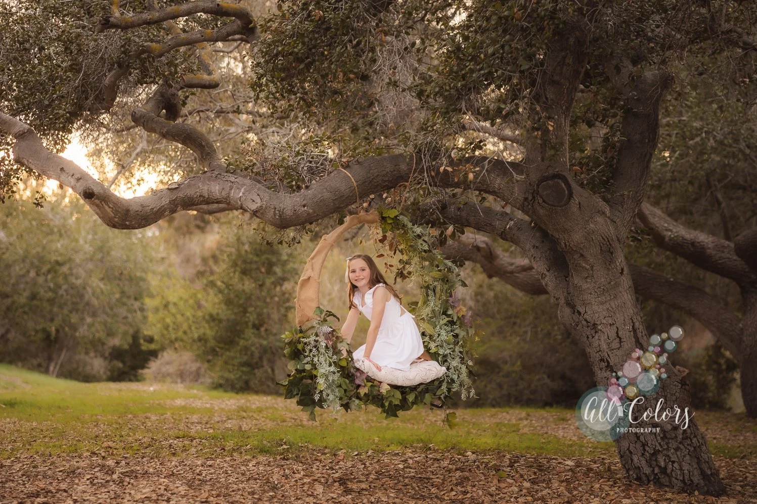 Girl wearing dress on a flower hoop/swing.