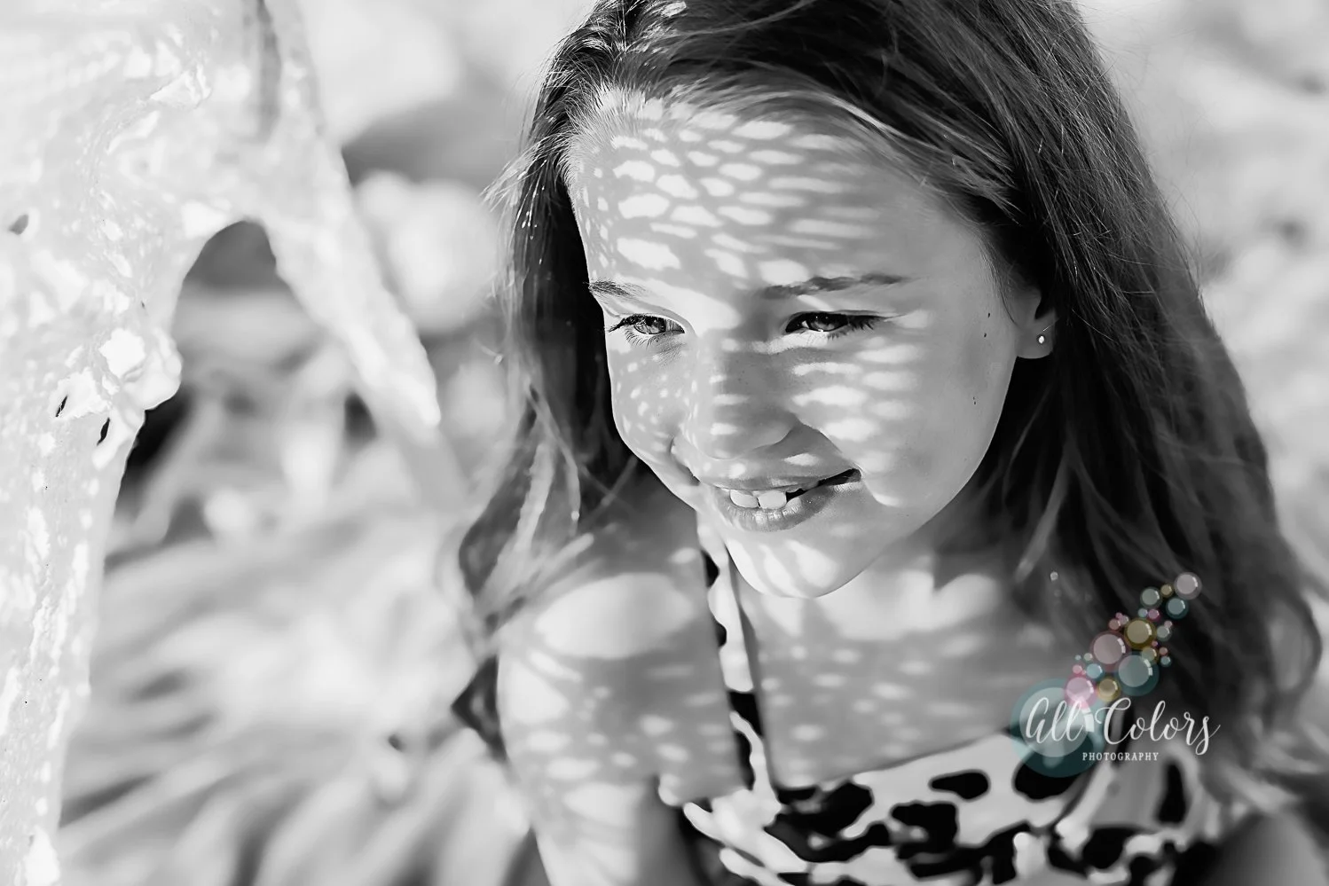 Black and white photo of a girl at the beach
