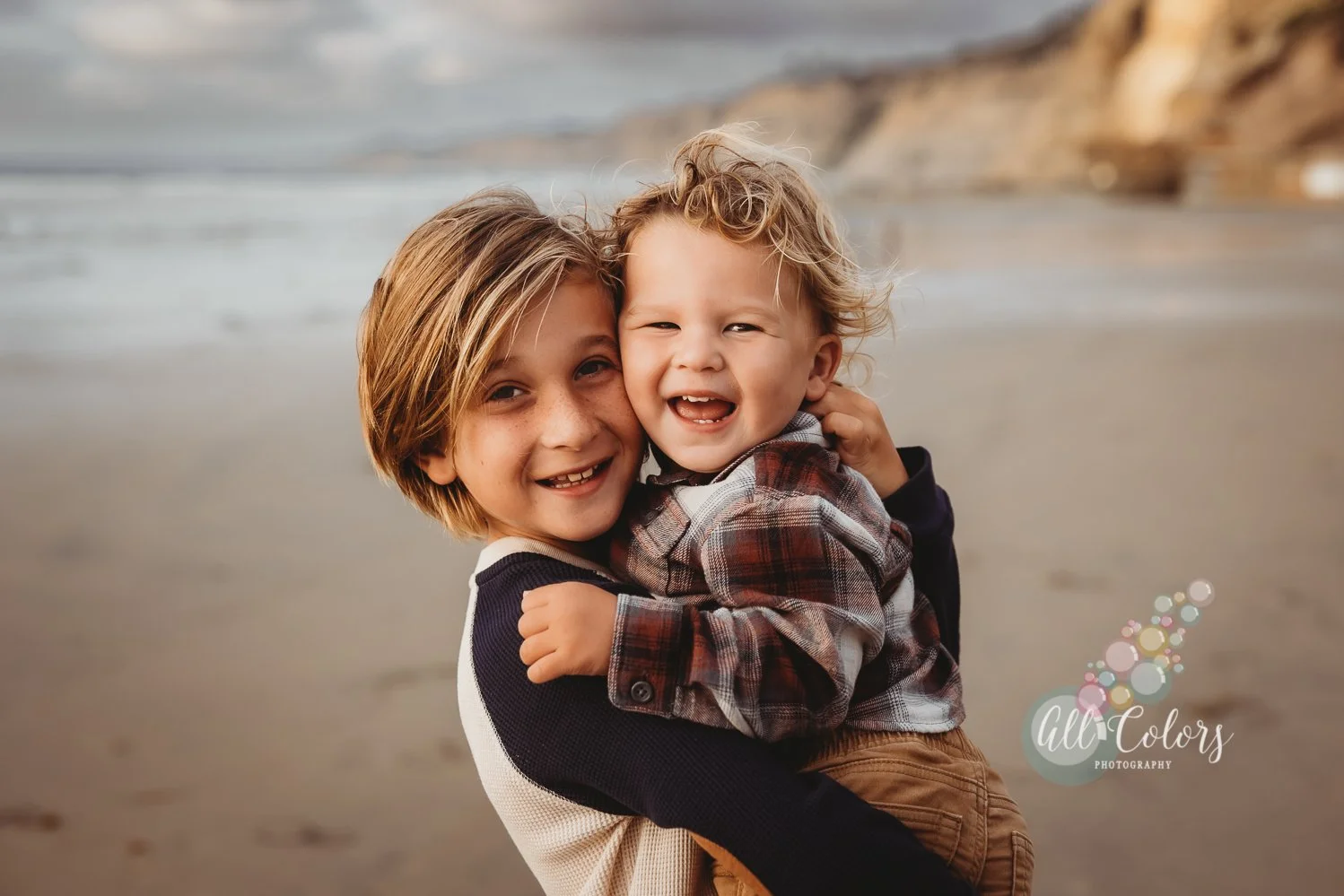 Two brothers hugging each other at the beach