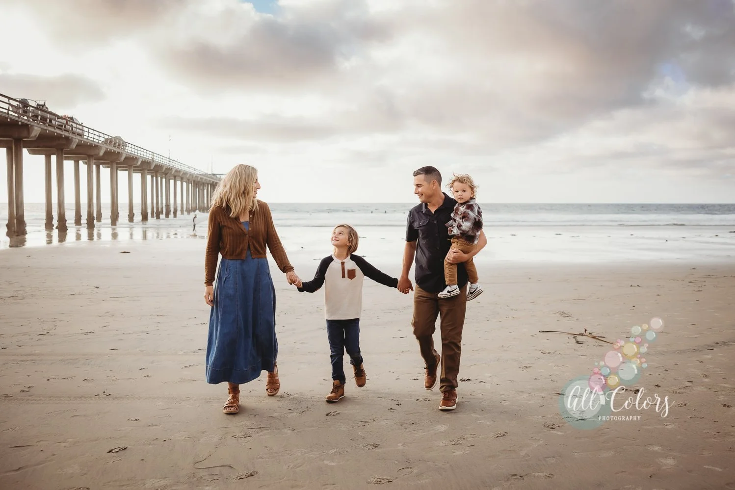 Family of four walking by the pier