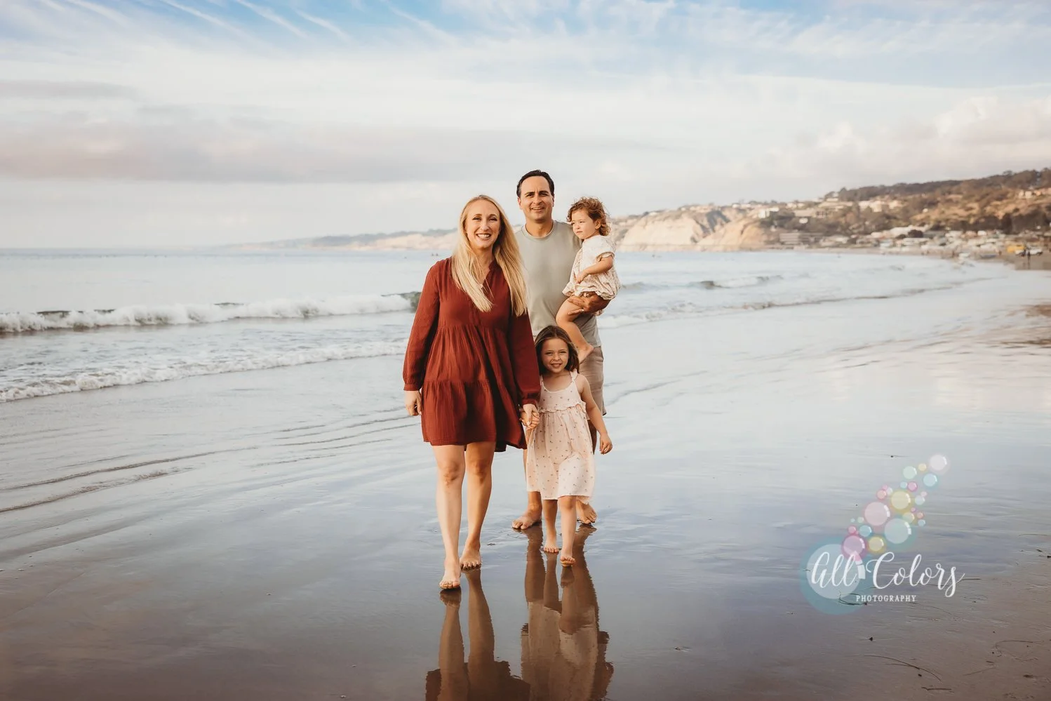 family of four walking on the beach in La Jolla, CA