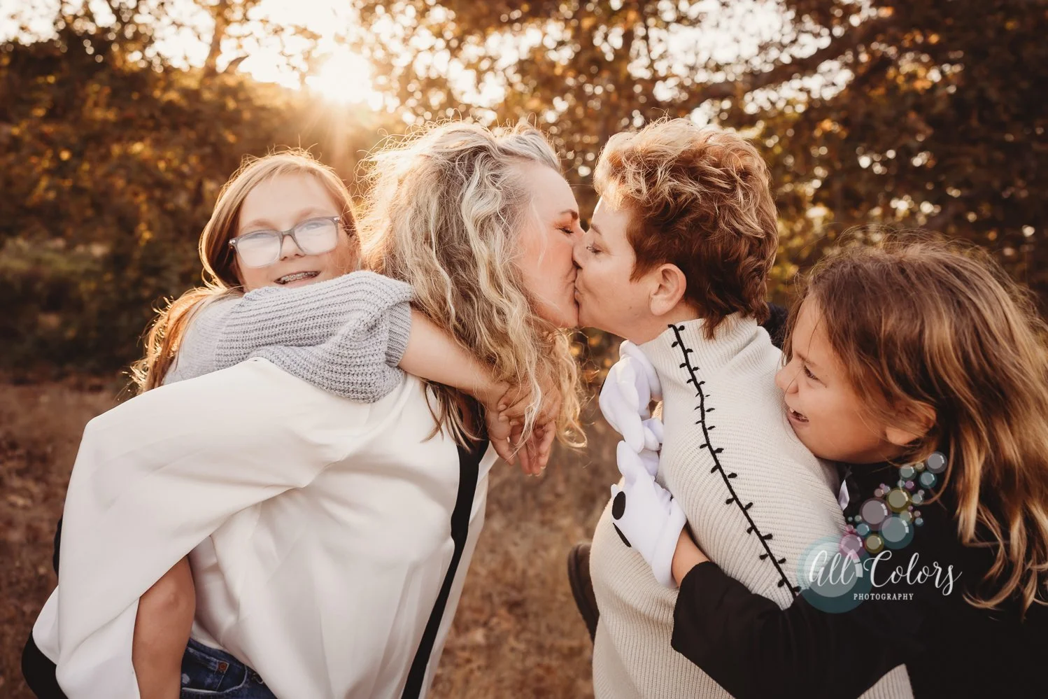 Same sex couple with their two daughters