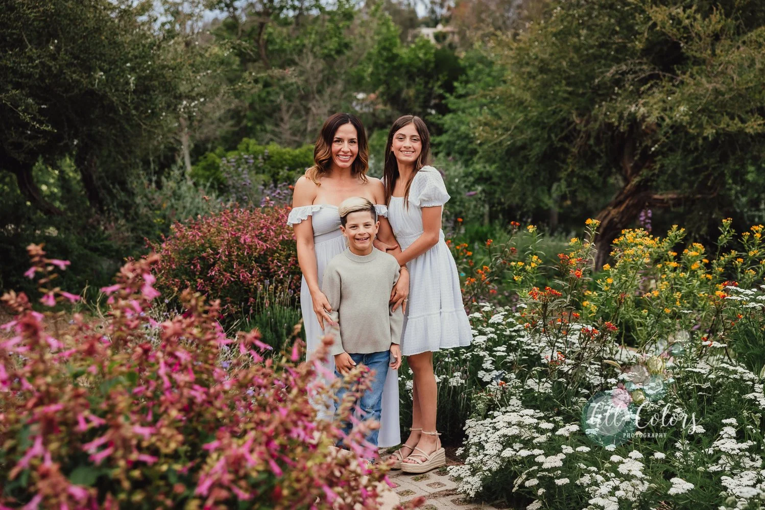Mom and 2 kids talking photos at a colorful garden