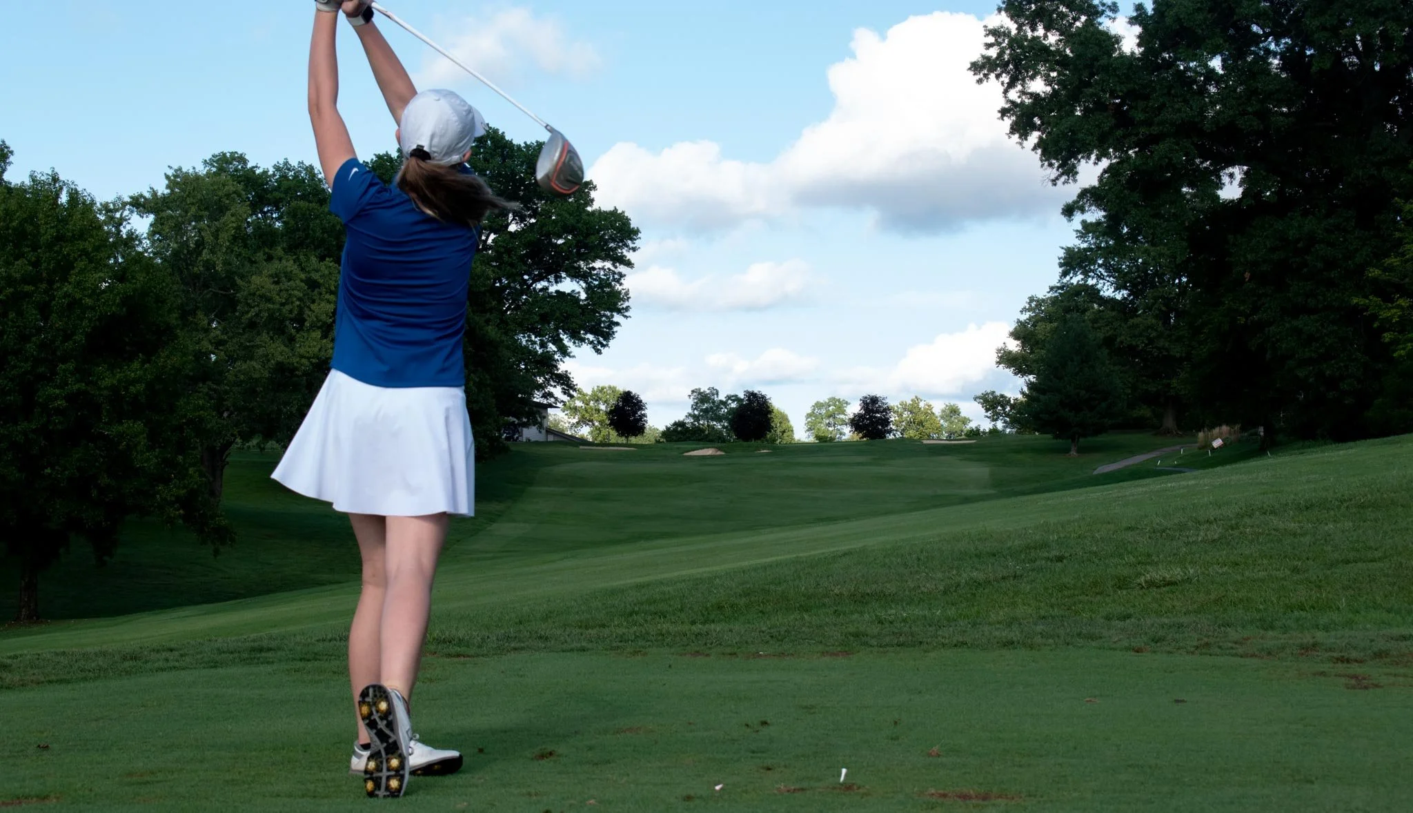 Penelope Kolb hits the ball into the hills of the golf course.jpg