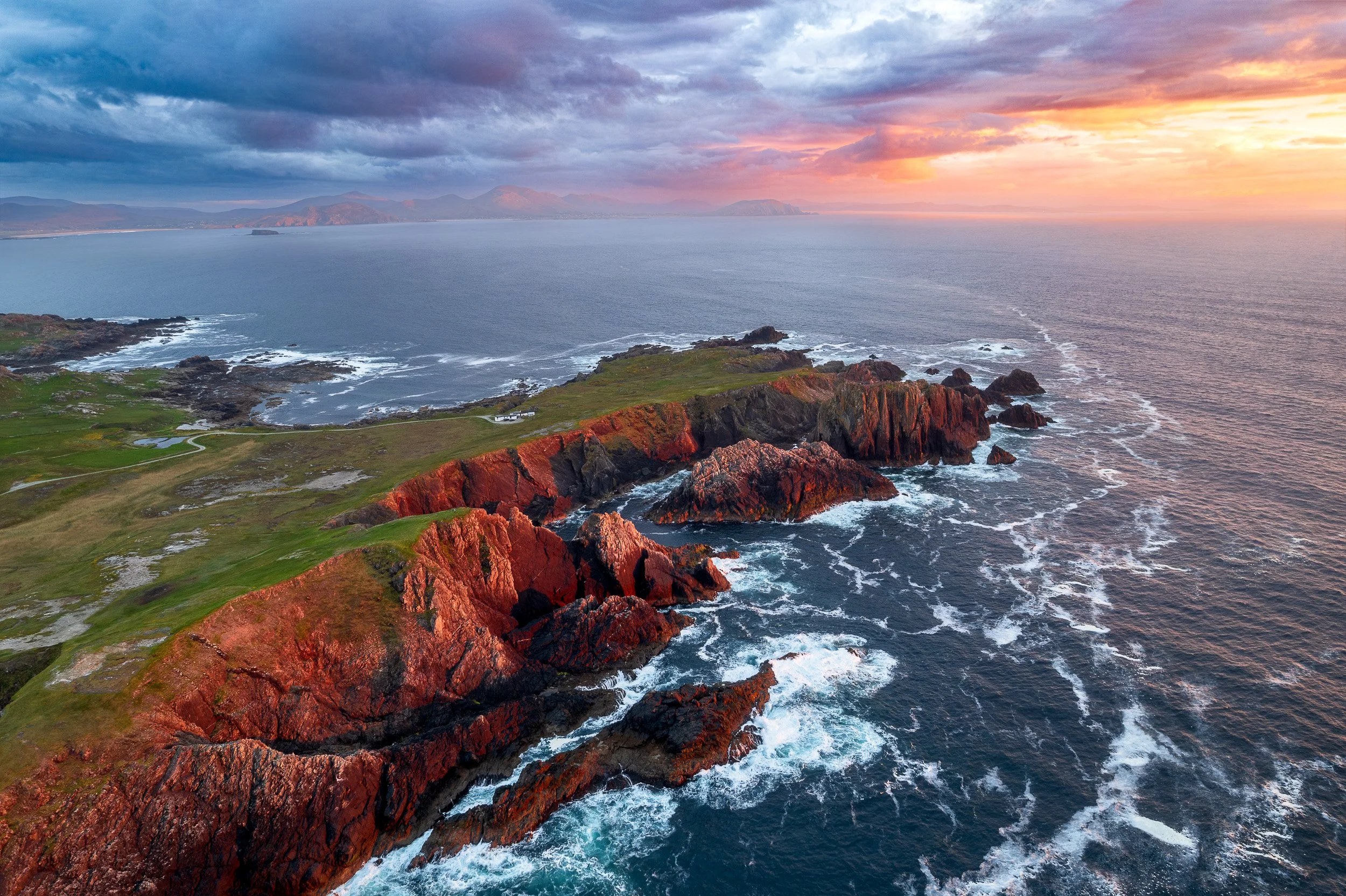 Aerial landscape photograph of Malin Head, County Donegal, Ireland at sunset.