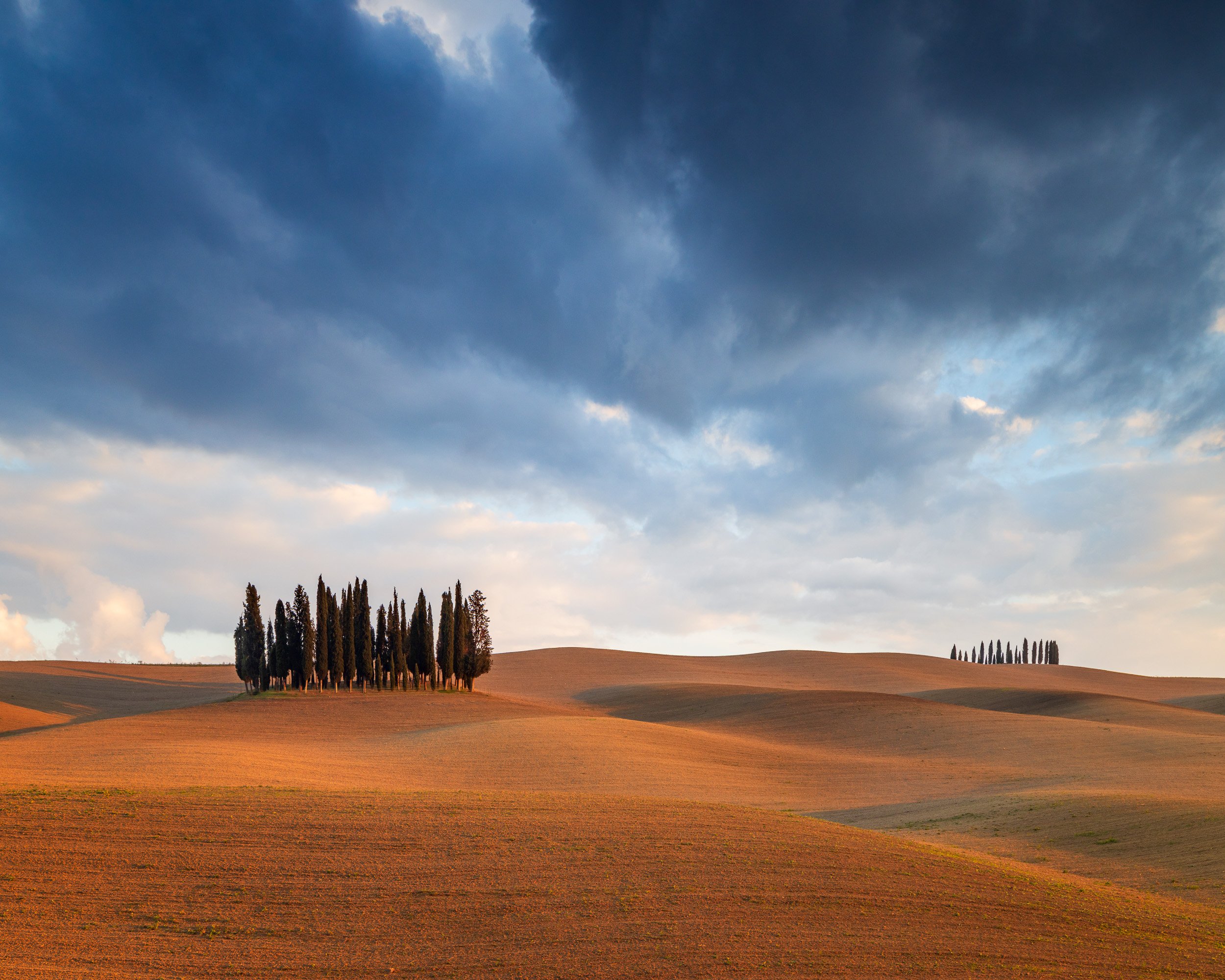 Landscape photograph of Cipressi di San Quirico d'Orcia, Val d'Orcia, Tuscany, Italy at sunset.