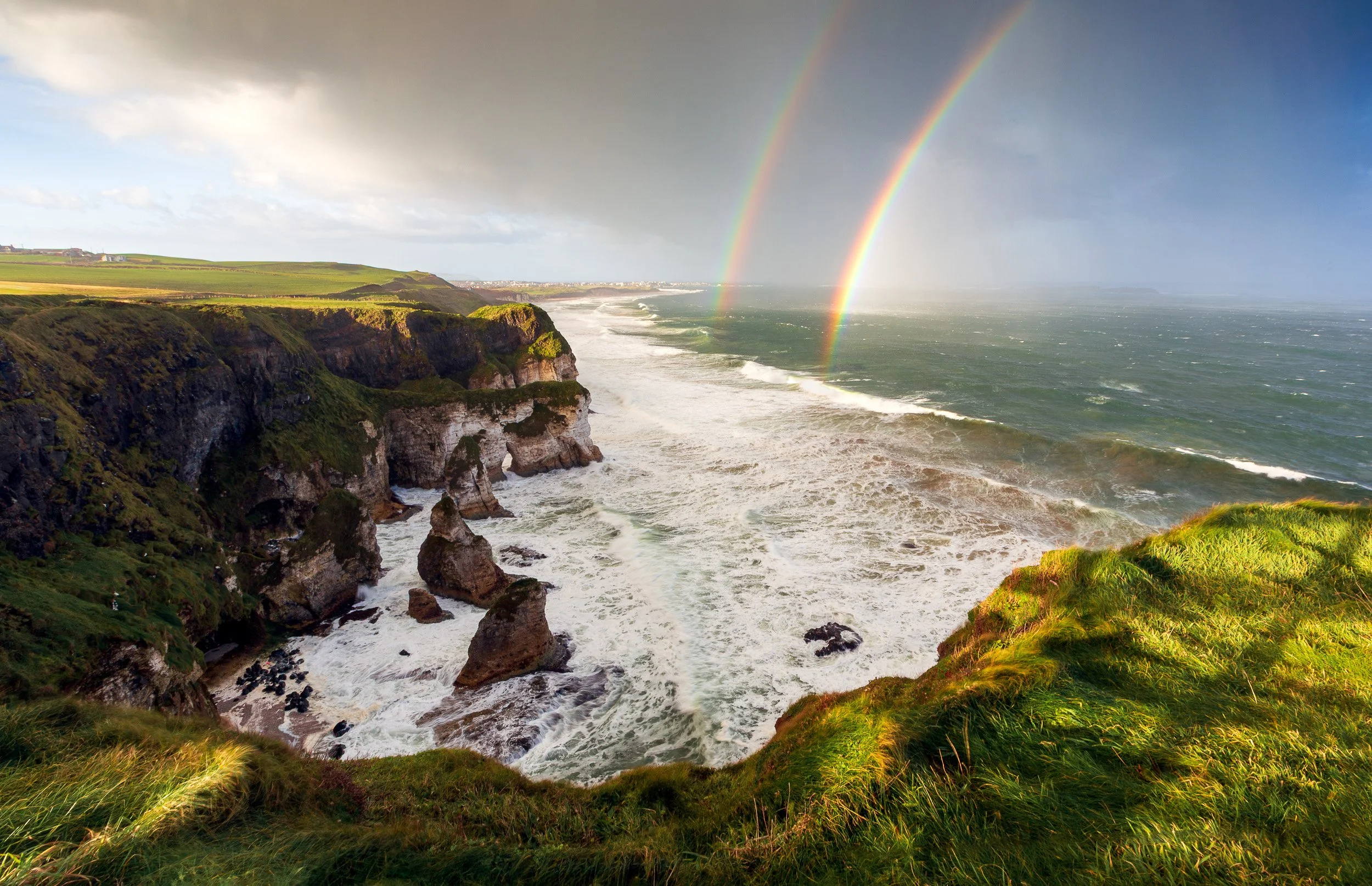 Landscape photograph of a double rainbow over Portrush, Northern Ireland, taken from Magheracross Viewpoint.