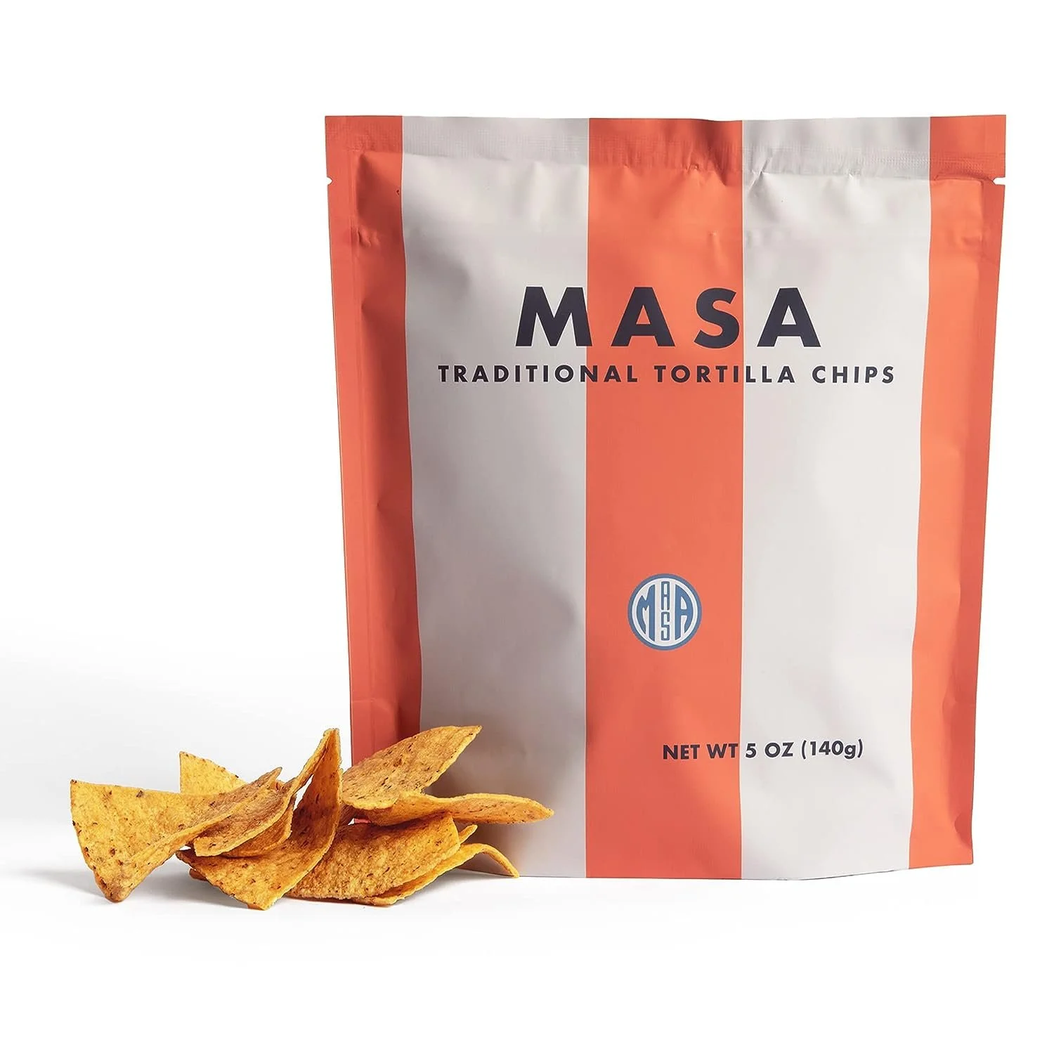 A bag of MASA traditional tortilla chips with some chips spilled in front of it. The bag is orange and white with a blue logo, and indicates it contains 5 ounces (140 grams).