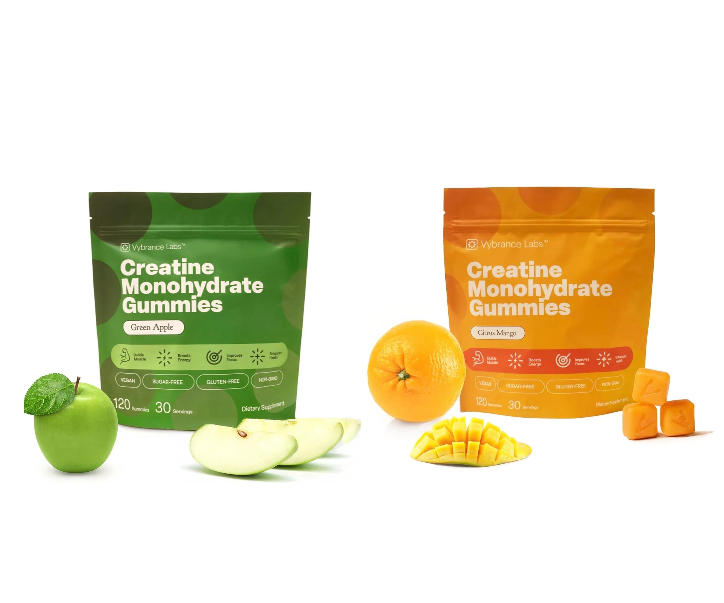 Two packages of creatine monohydrate gummies, one green apple flavor and one citrus mango flavor, with a green apple, pear slices, lemon, and mango pieces displayed beside them.