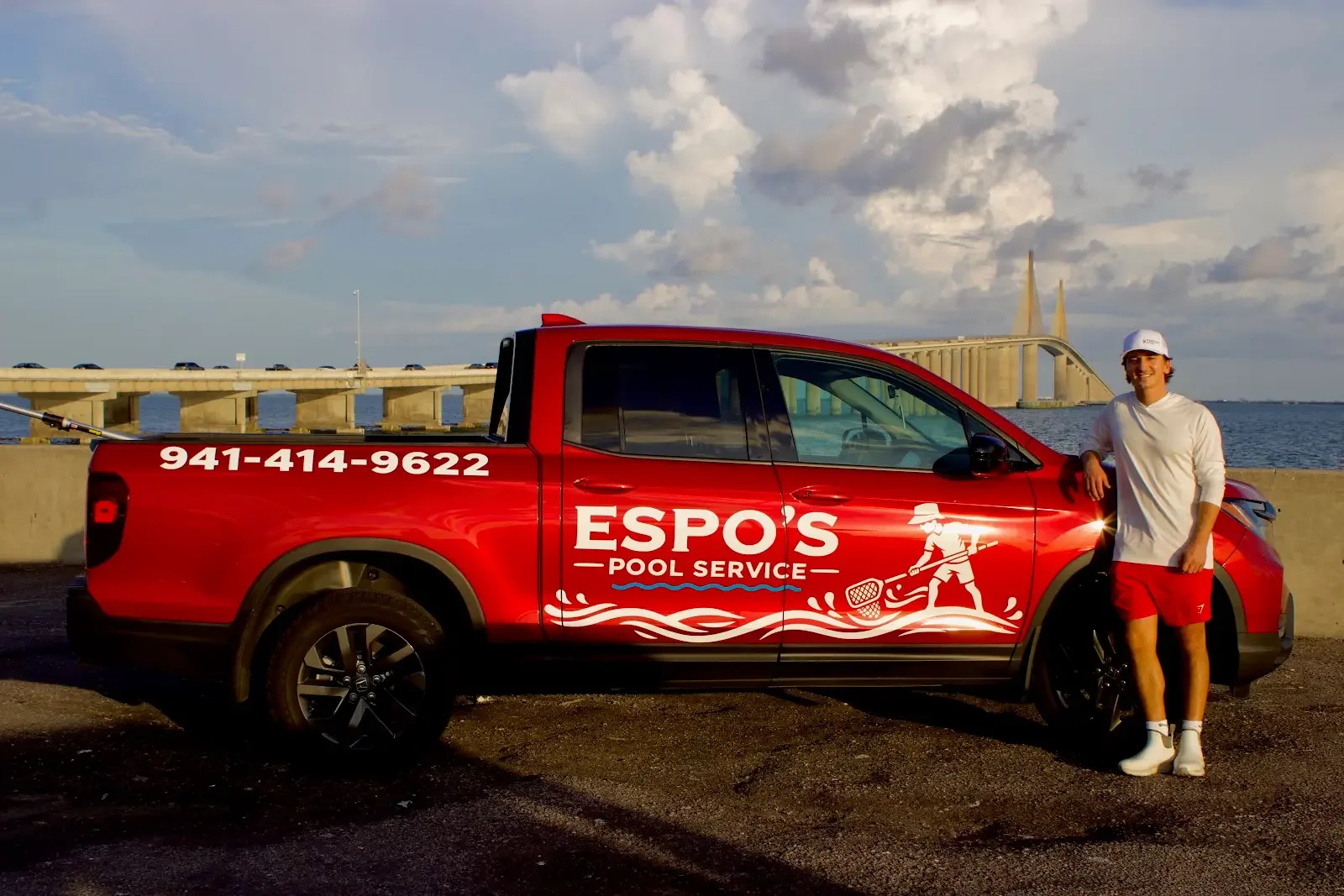 Espo's Pool Service owner standing beside branded pool cleaning truck