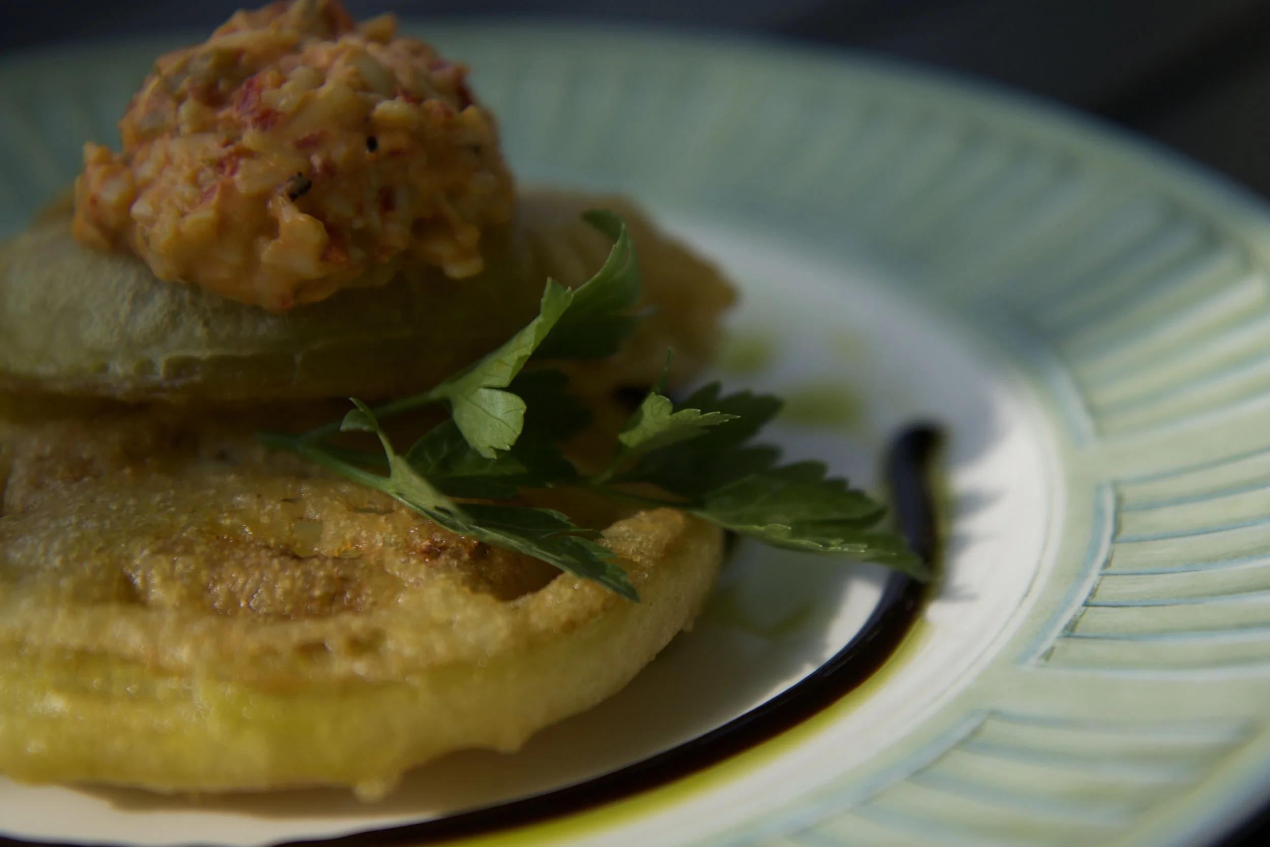 Close-up of a tapas plate with a sprig of parsley.