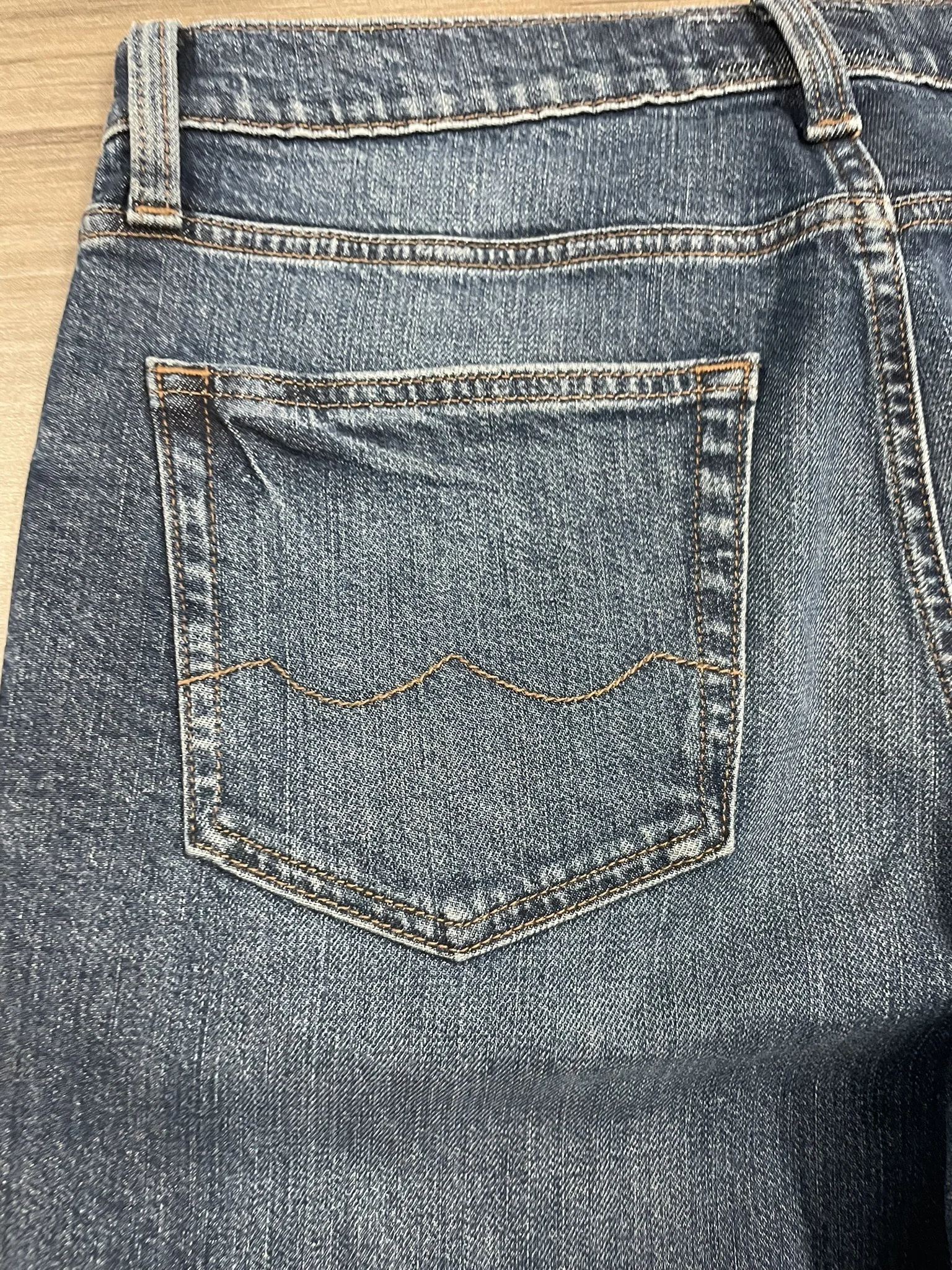 Back pocket shield motif stitching detail