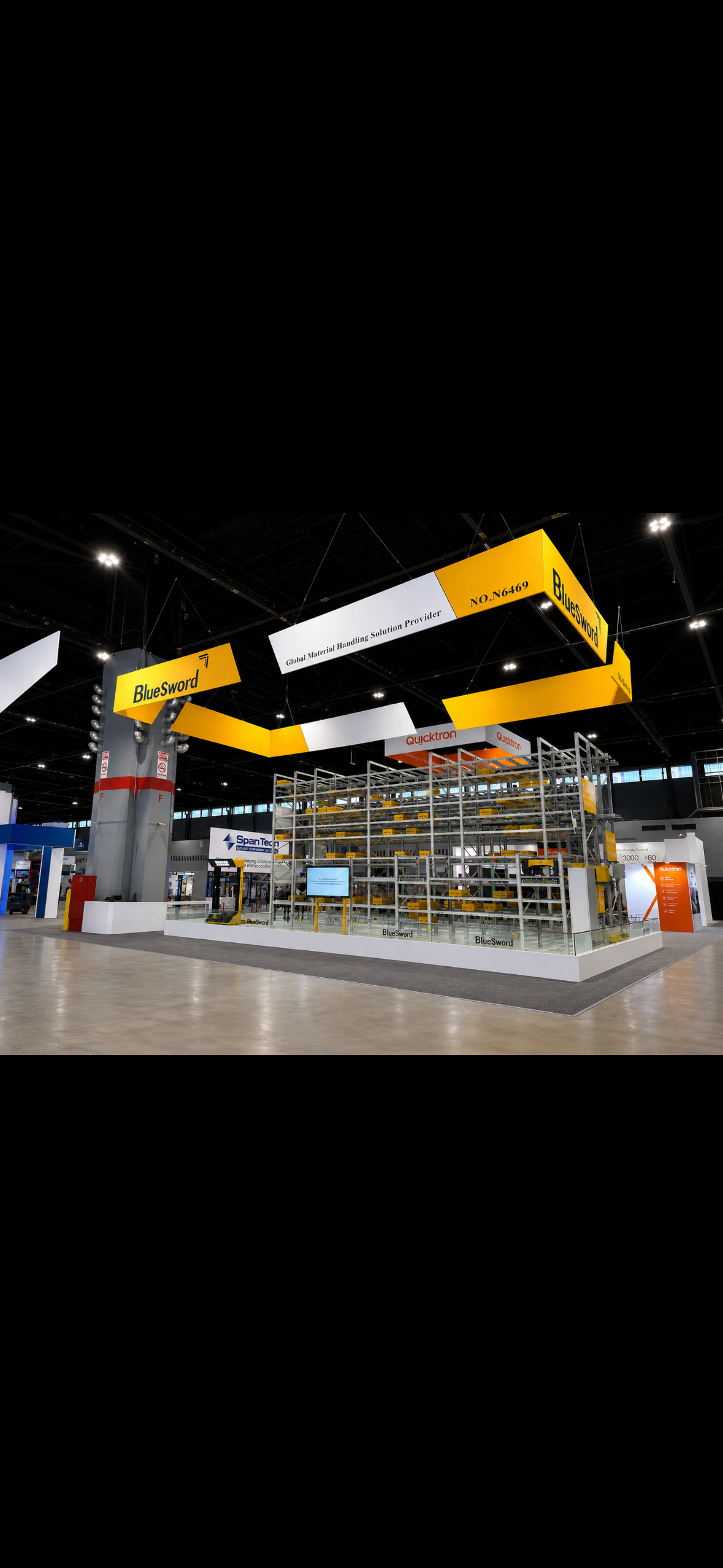 Trade show booth for BlueSword and other companies, featuring shelving with products, informational displays, and large hanging overhead with brand names and descriptions at McCormick Place - Chicago, IL