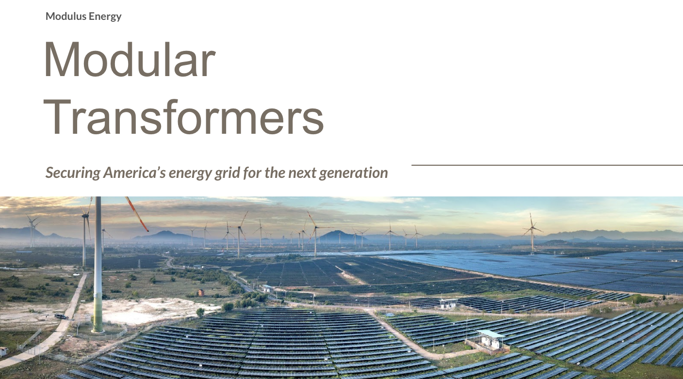 Aerial view of a solar and wind energy farm with solar panels and wind turbines, mountains in the background, during sunset.