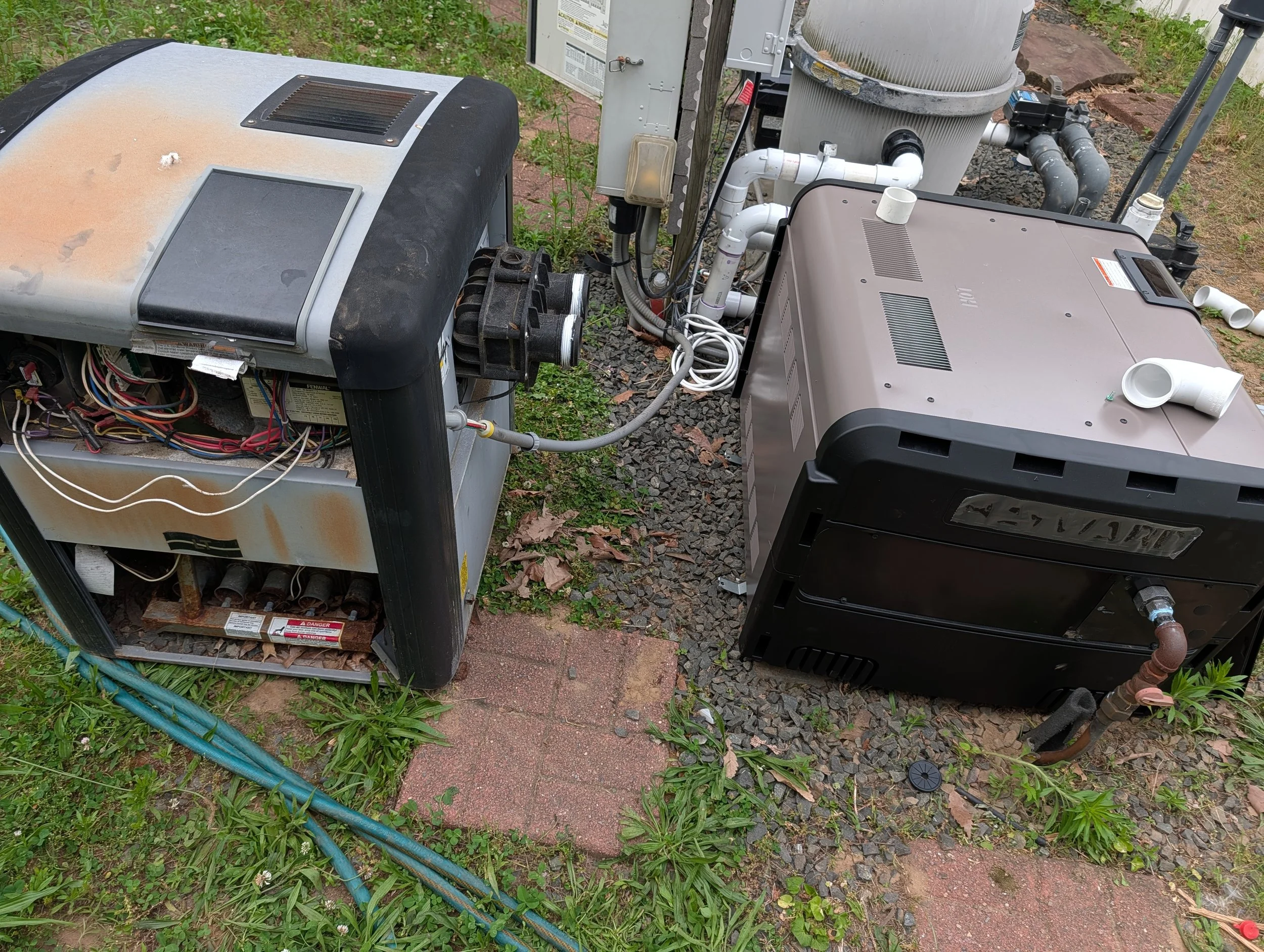Outdoor view of HVAC equipment and pool pump system on a patch of grass and gravel, with pipes, wiring, and equipment components visible.