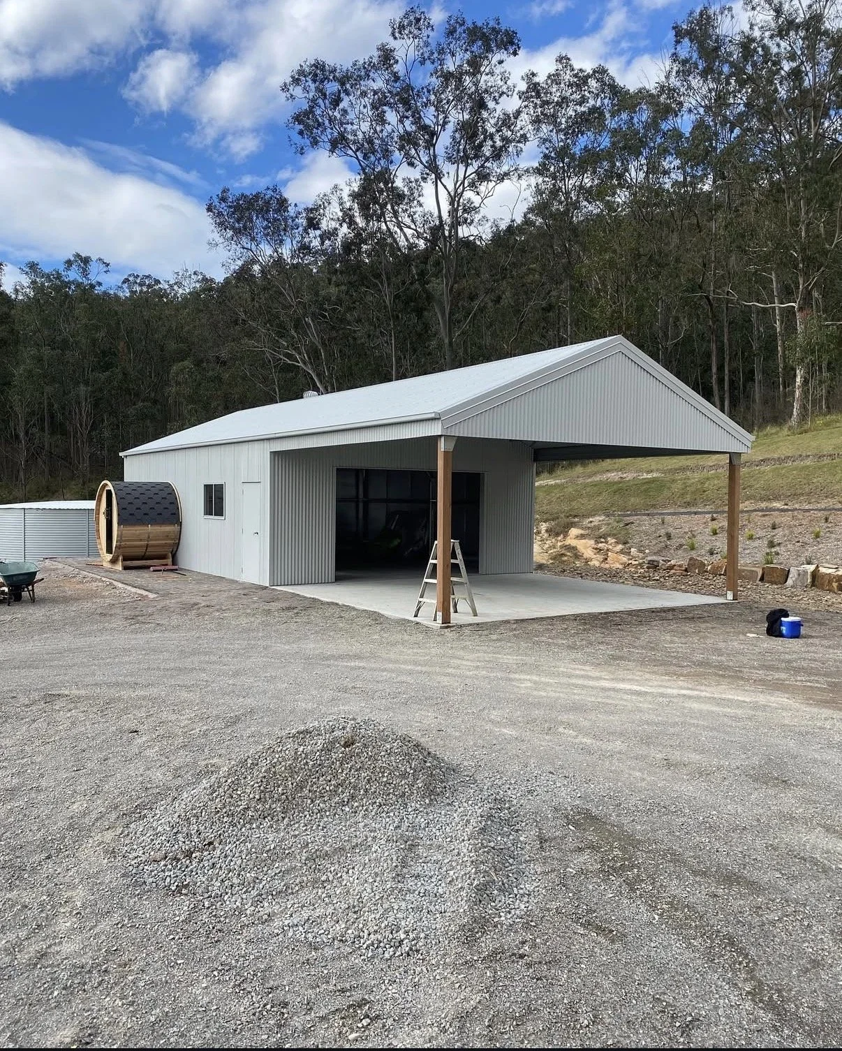 Surfmist with a gabled roof and open front, supported by two timber posts,