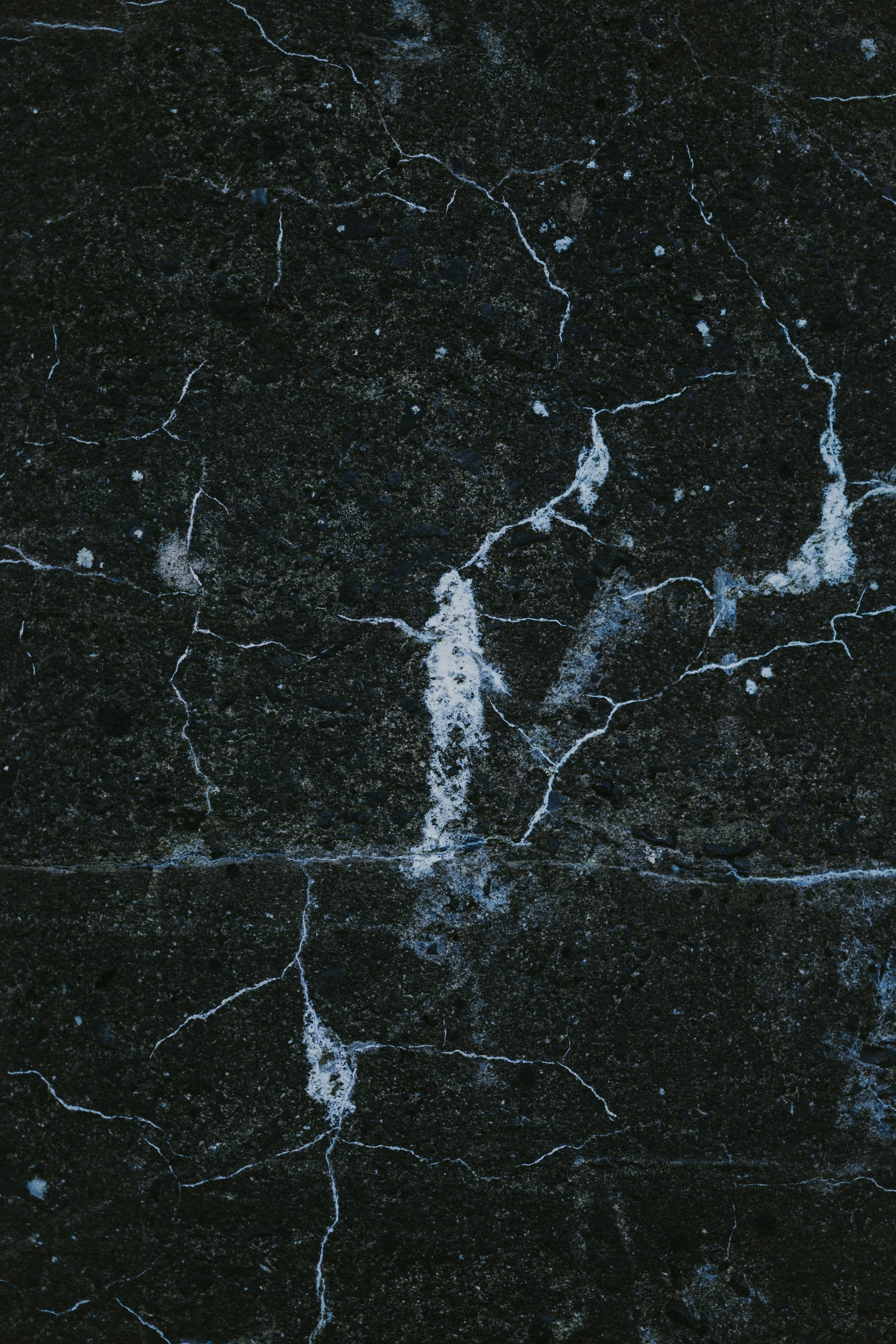 Close-up of dark black marble with intricate white veining and natural mineral patterns