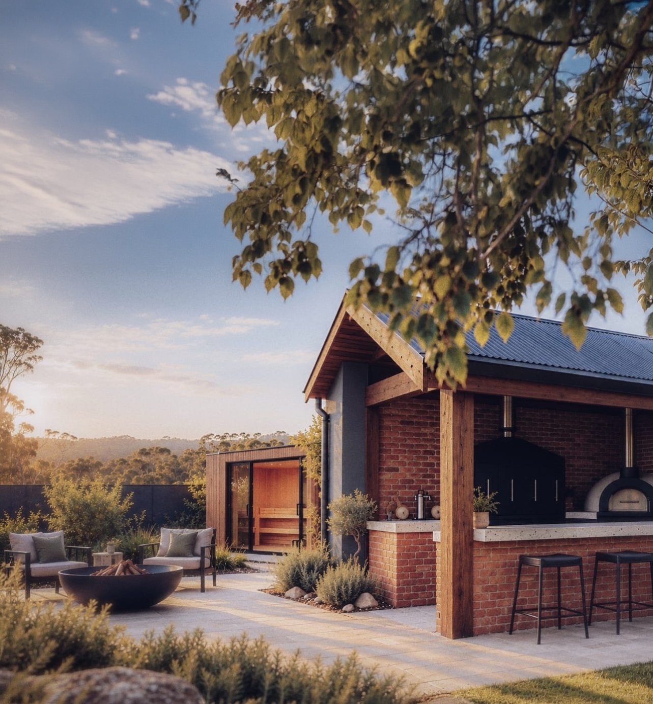 Modern brick outdoor kitchen and patio with pizza oven, bar stools, fire pit, and lounge seating at sunset