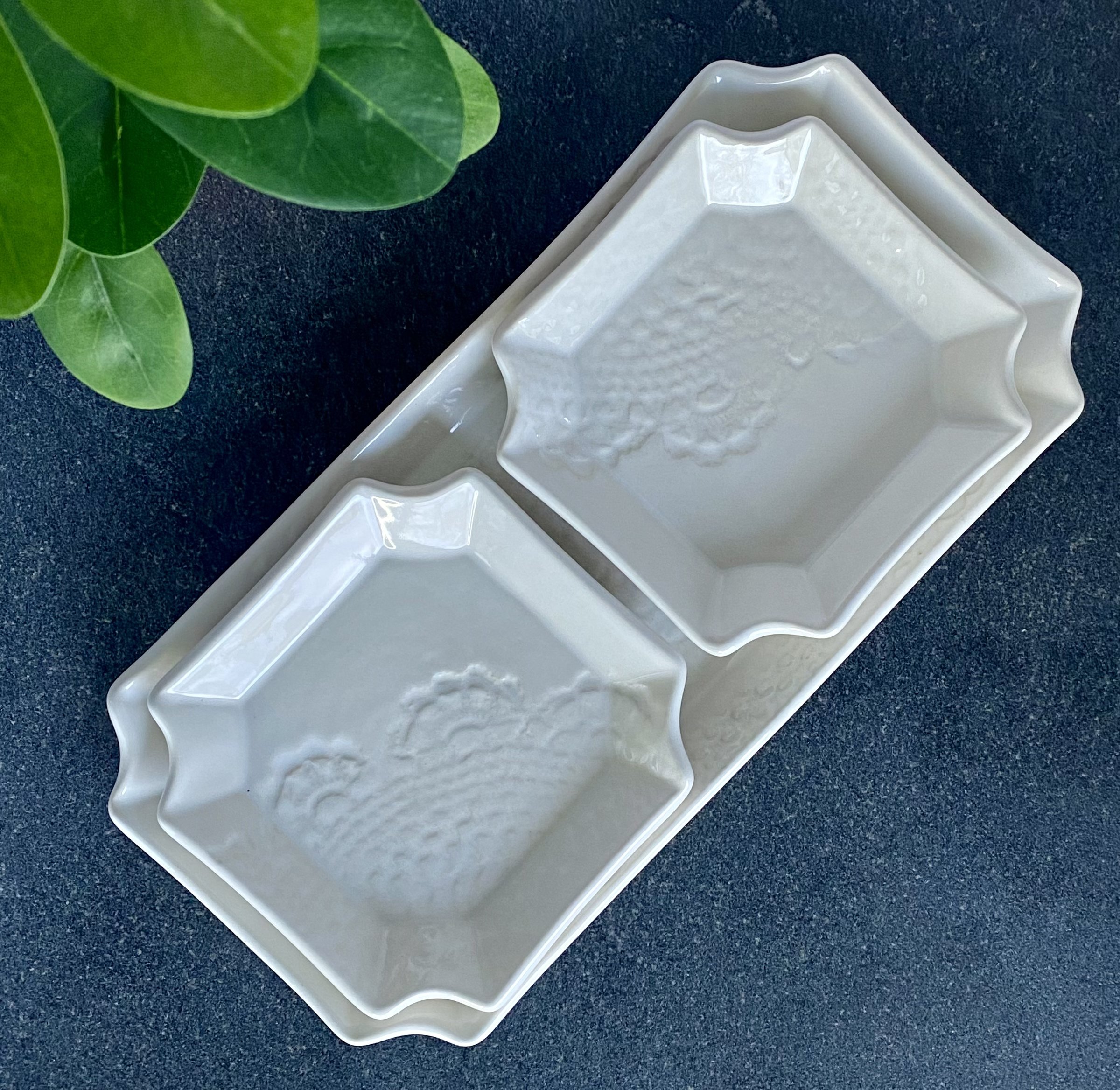 White ceramic hand-built trinket dishes. Two square dishes nested in a rectangular dish.