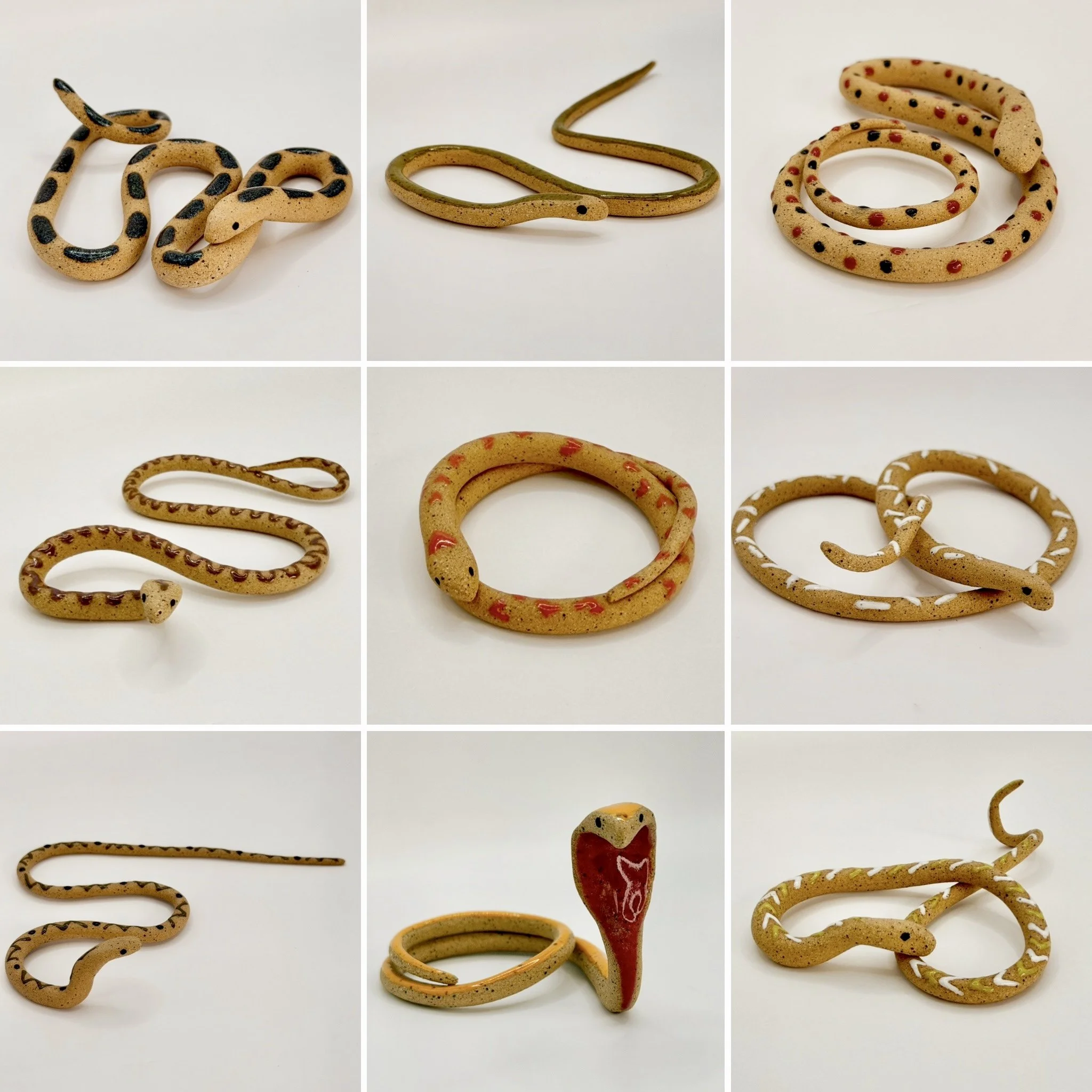 Collection of decorative and fun ceramic snakes, each with different colors and patterns, arranged on a white surface.
