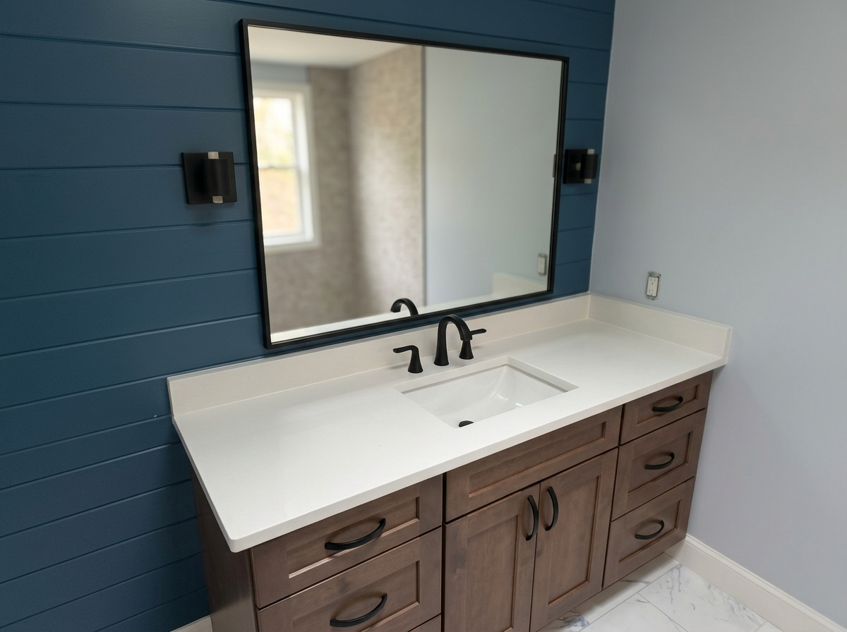 Bathroom vanity with a white countertop, a built-in sink, and black faucet, set against a blue wall with a large mirror and black wall sconces.
