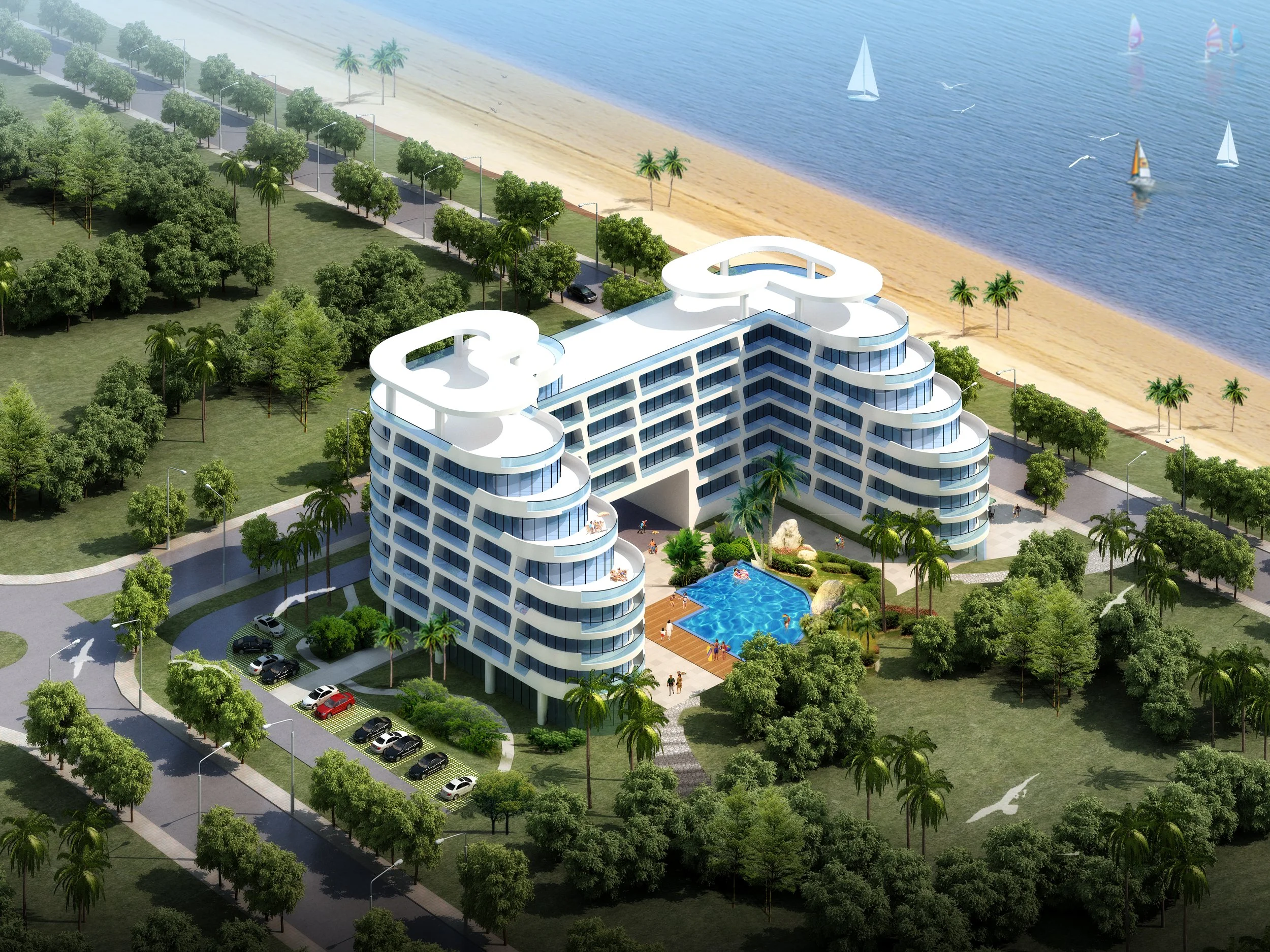 A modern white building with multiple floors, balconies, and rooftop structures overlooking a beach and ocean. There are sailboats on the water, a swimming pool on the lower level, and lush green trees surrounding the area. A parking lot with cars is visible at the front.