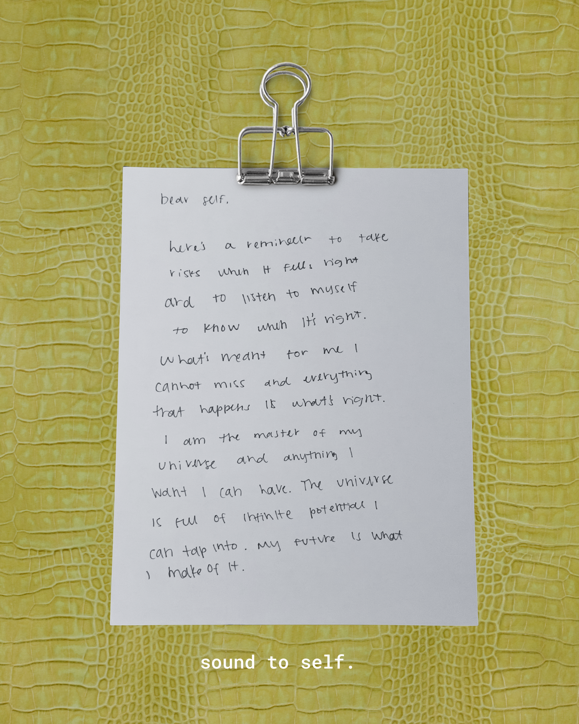 A handwritten note attached to a yellow alligator-textured surface with a silver clip. The note discusses the importance of listening to oneself and understanding what happiness means, and includes the phrase "sound to self" at the bottom.