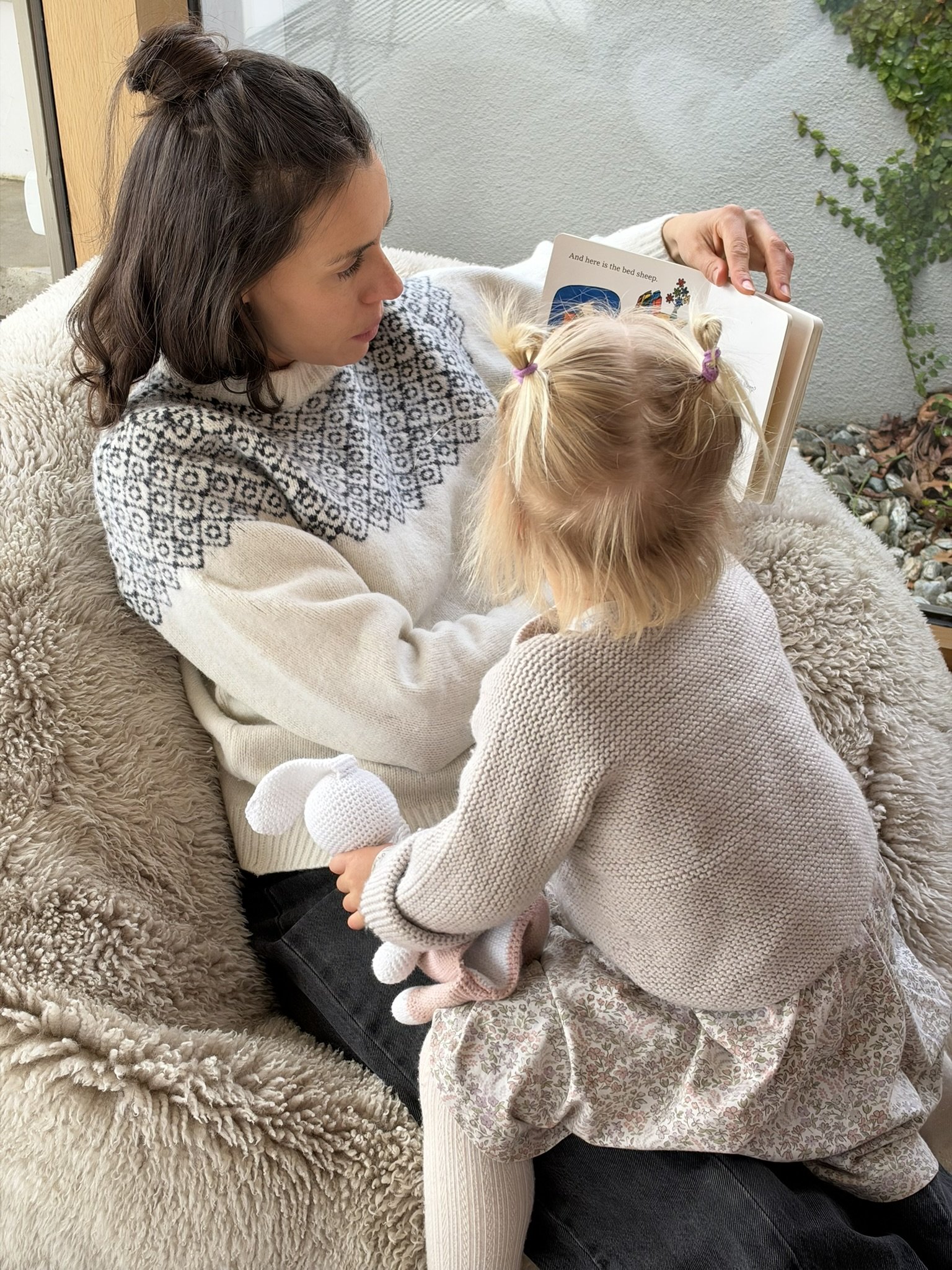 Georgie a Queenstown sleep consultant reading a book to her daughter.