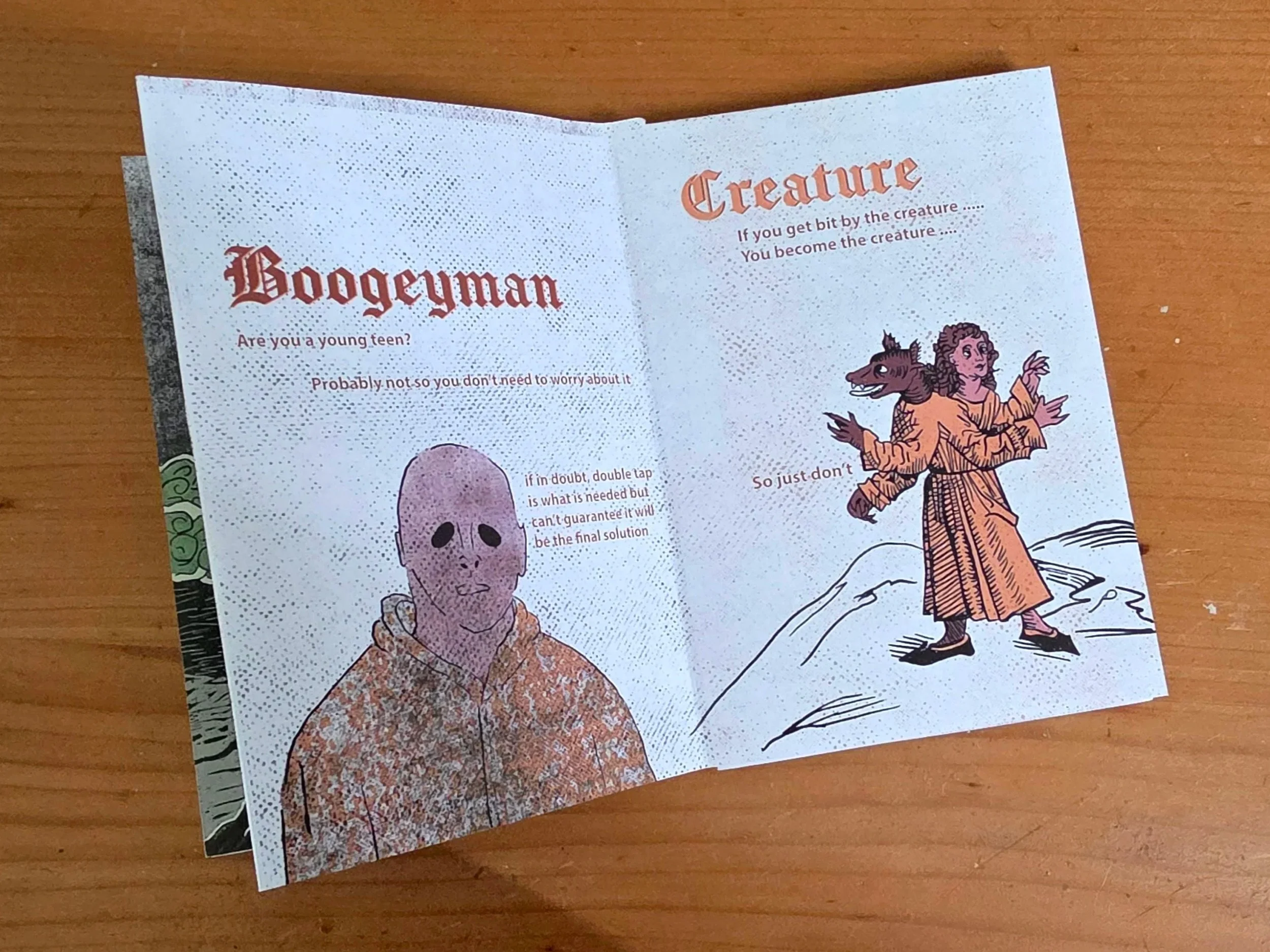 A folded paper with cartoon illustrations and text, featuring a humanoid skeleton and a fairy tale character with wings and curly hair, on a wooden surface.