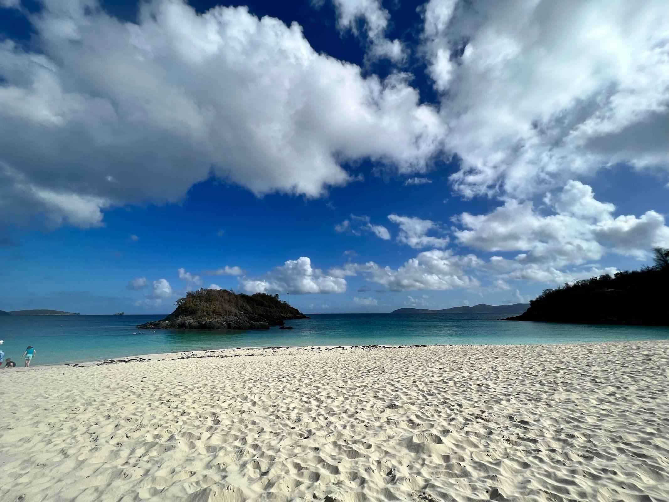 White sand beach and turquoise Caribbean water under a blue sky in the US Virgin Islands