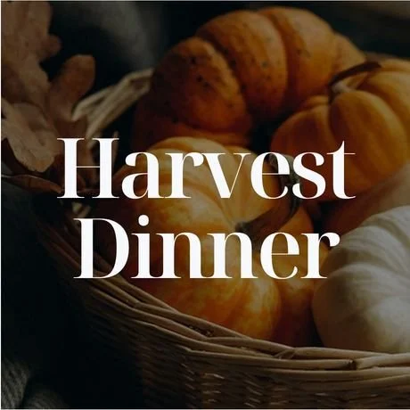 A basket of pumpkins with the text 'Harvest Dinner' overlayed.