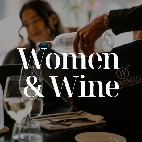 Woman pouring wine with friend
