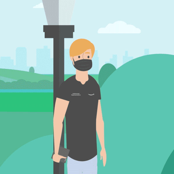 A person in a black mask and black t-shirt standing outdoors in a park with a city skyline in the background.