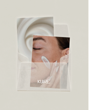 Close-up of a woman applying skincare cream to her face, with a circular dish in the background