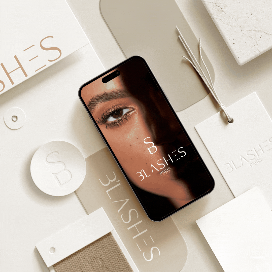 A smartphone with a close-up photo of a woman's eye on its screen, surrounded by various white and beige beauty product packaging and tags branded with '3LASH'S PARIS'.