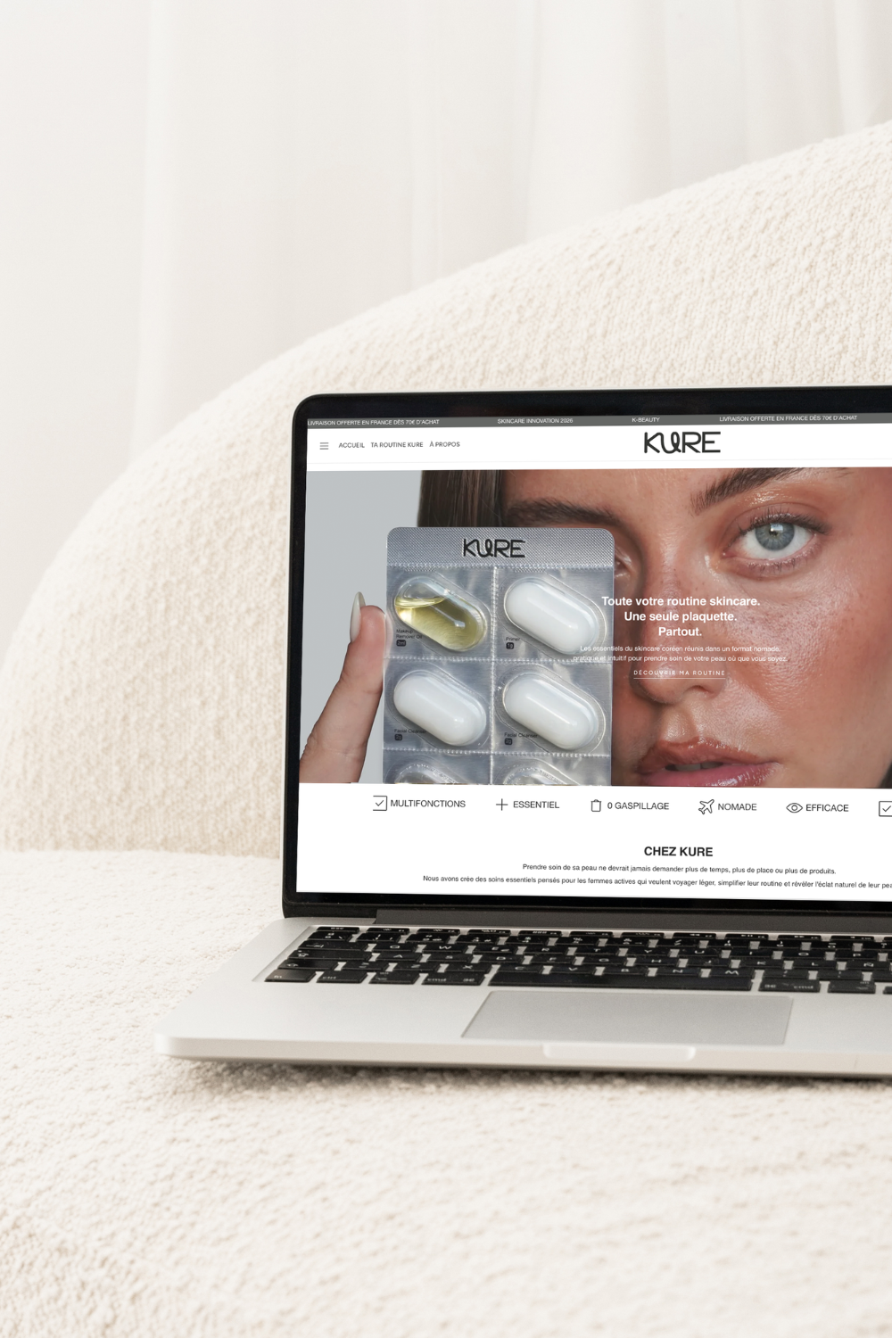 Laptop displaying a skincare product website with a woman holding a blister pack of pills.