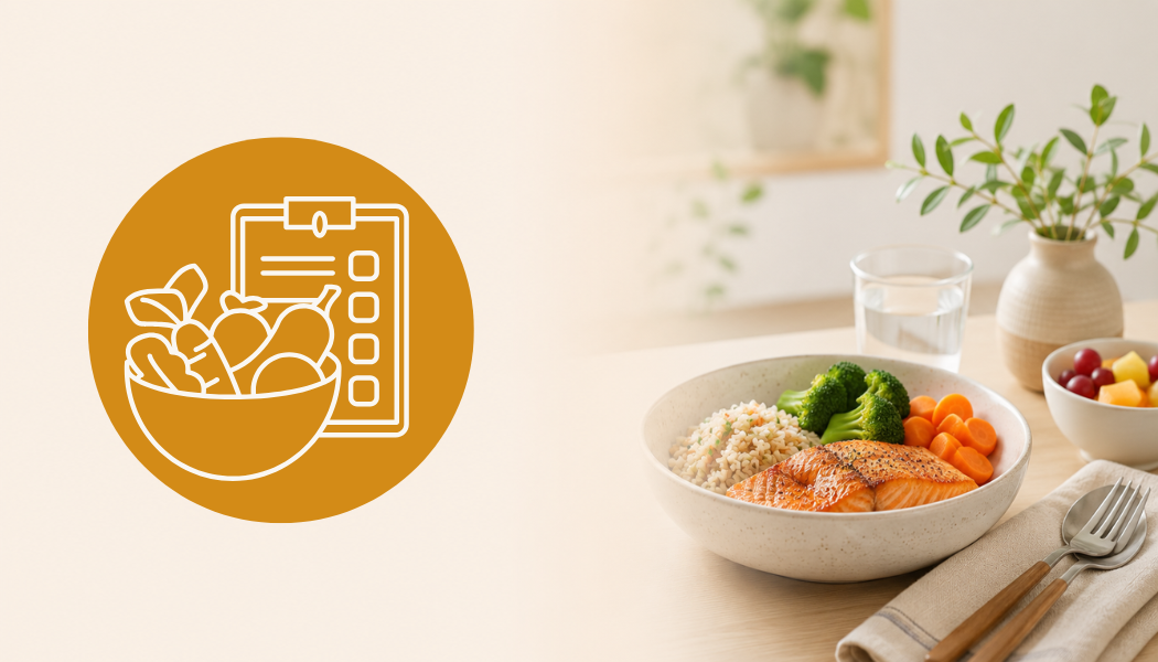 Healthy balanced meal with salmon, rice, broccoli, carrots, and fruit in a bowl on a dining table
