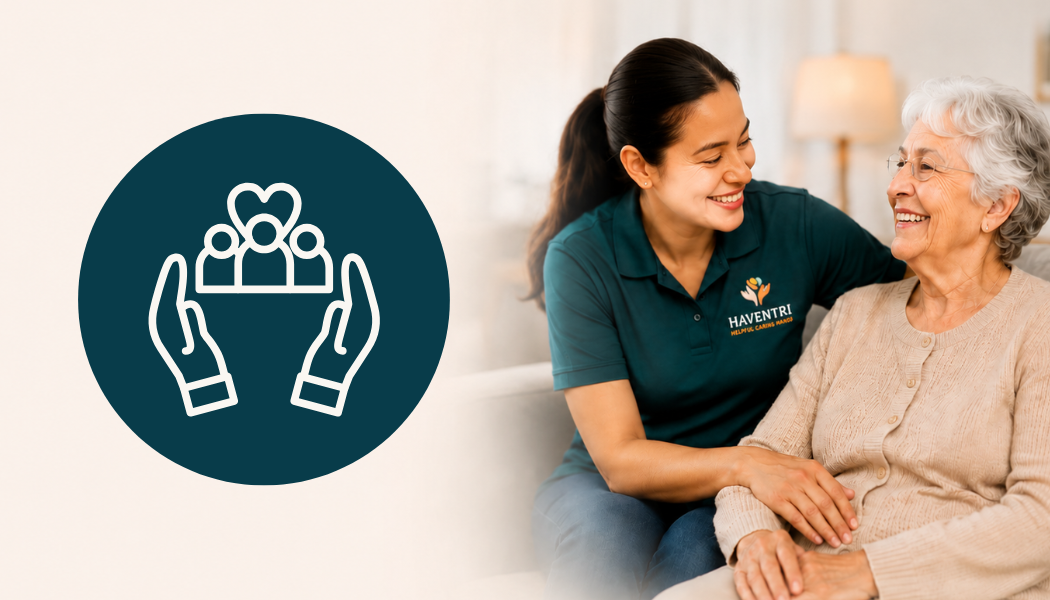 A young caregiver smiling and talking with an elderly woman in a comfortable living room.