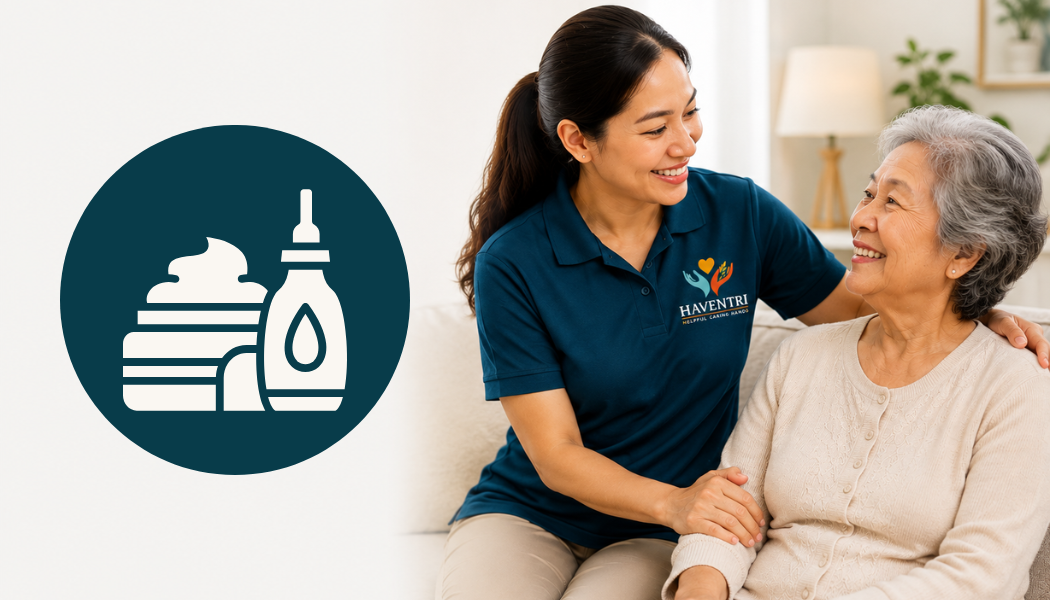 A caregiver and an elderly woman sitting on a couch, smiling and holding hands, in a living room with a lamp and plant in the background, with an icon of cake, soap, and lotion beside them.