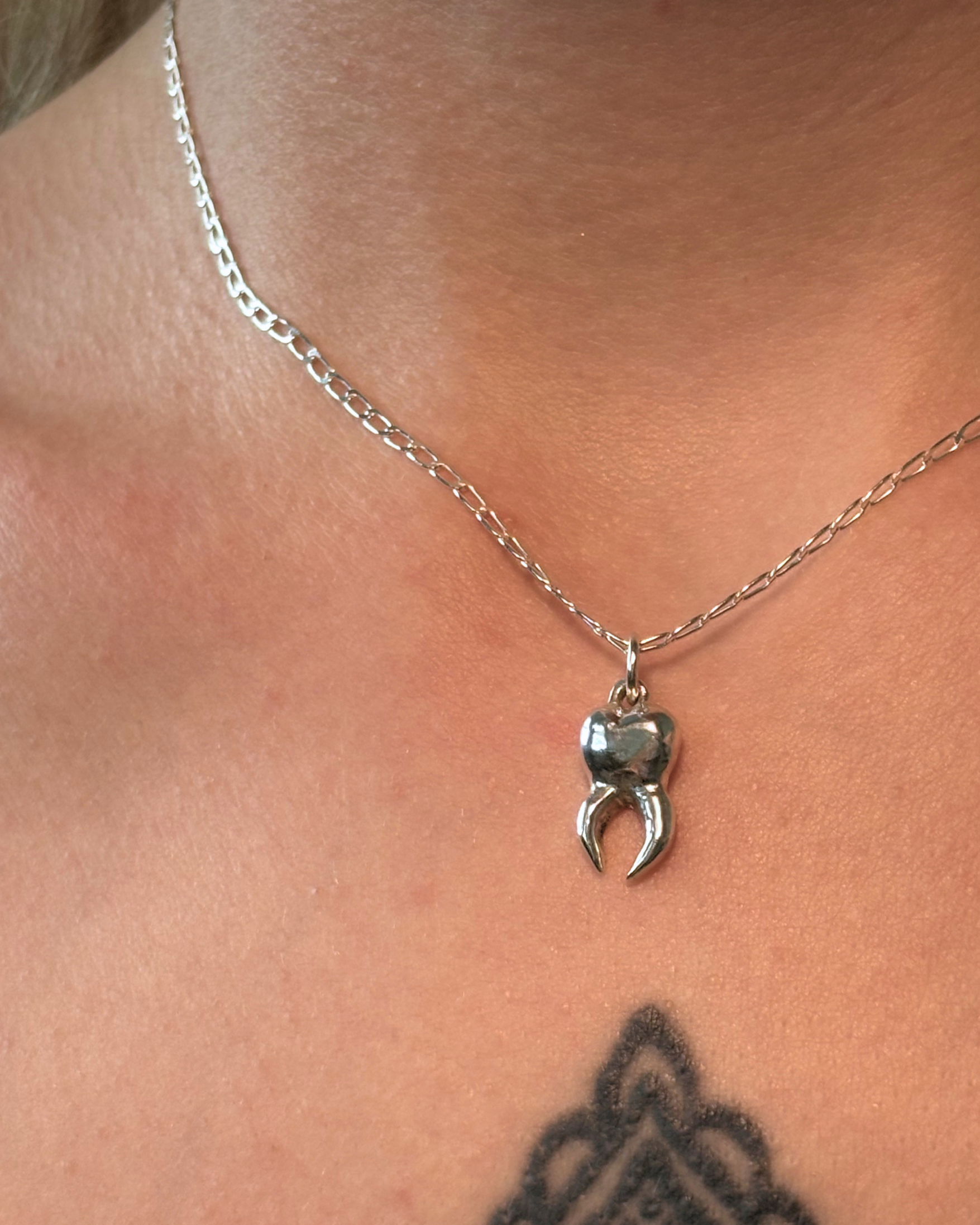 Sugar tooth pendant on paper clip necklace being worn