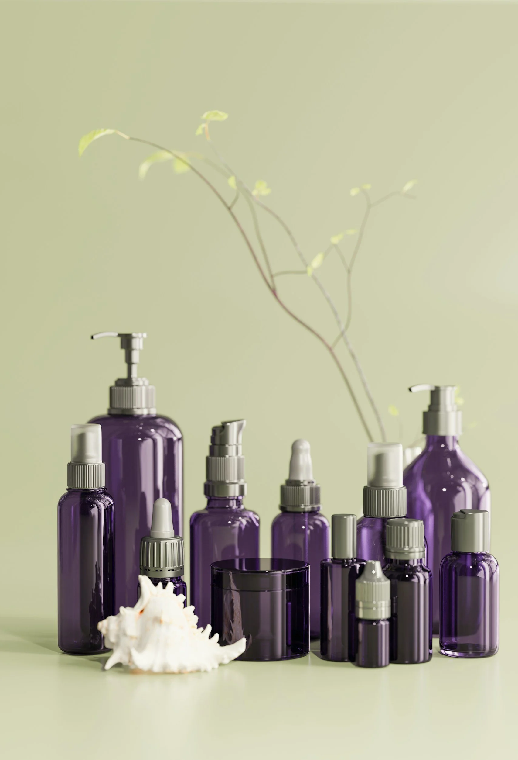 A collection of various purple glass bottles and jars with spray nozzles, arranged on a light green surface with a matching green background. There is also a white seashell and a dried branch with small leaves among the bottles.