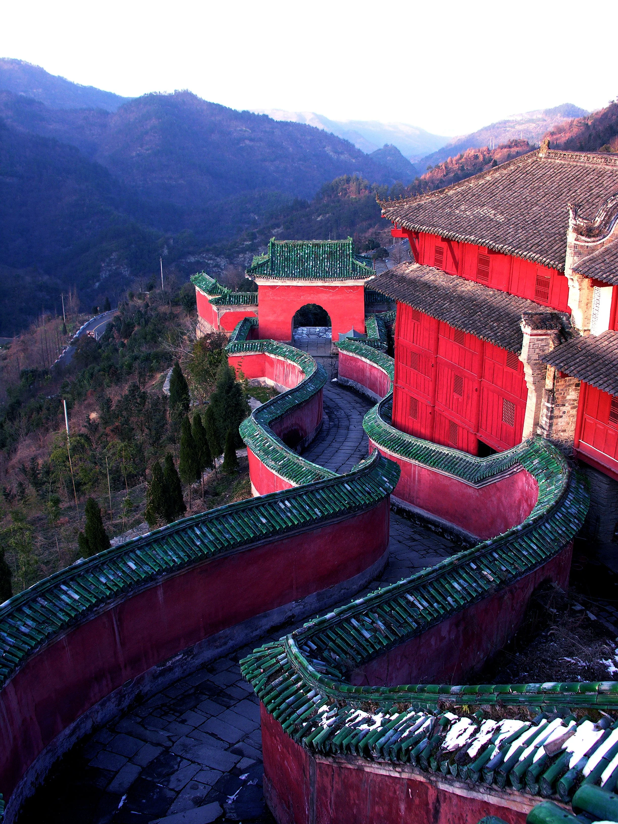 Aerial view of the winding red rampart walls of Wudang Mountain at sunset
