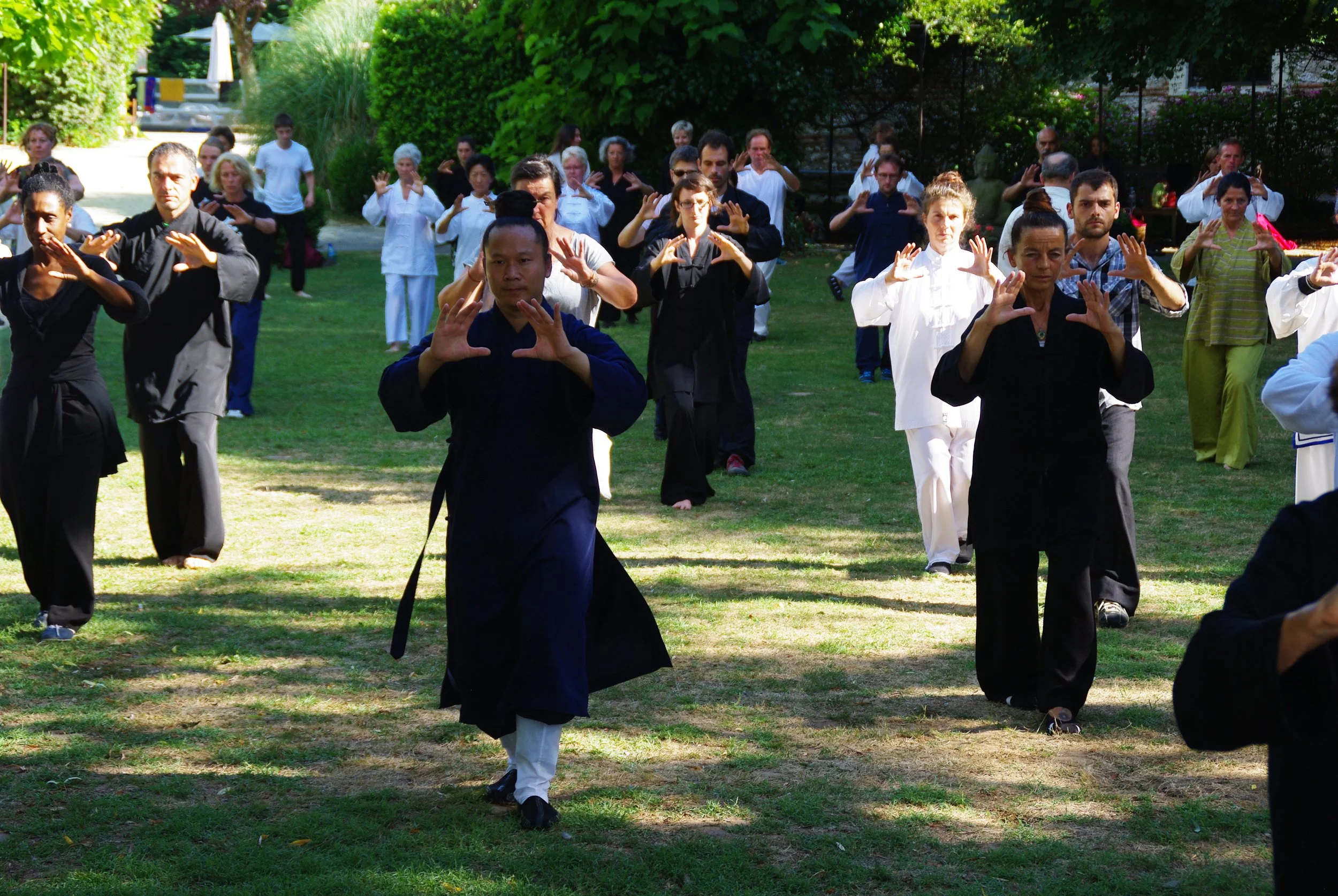 Instructor leading an outdoor Wudang Gong Dao practice session with students in a park