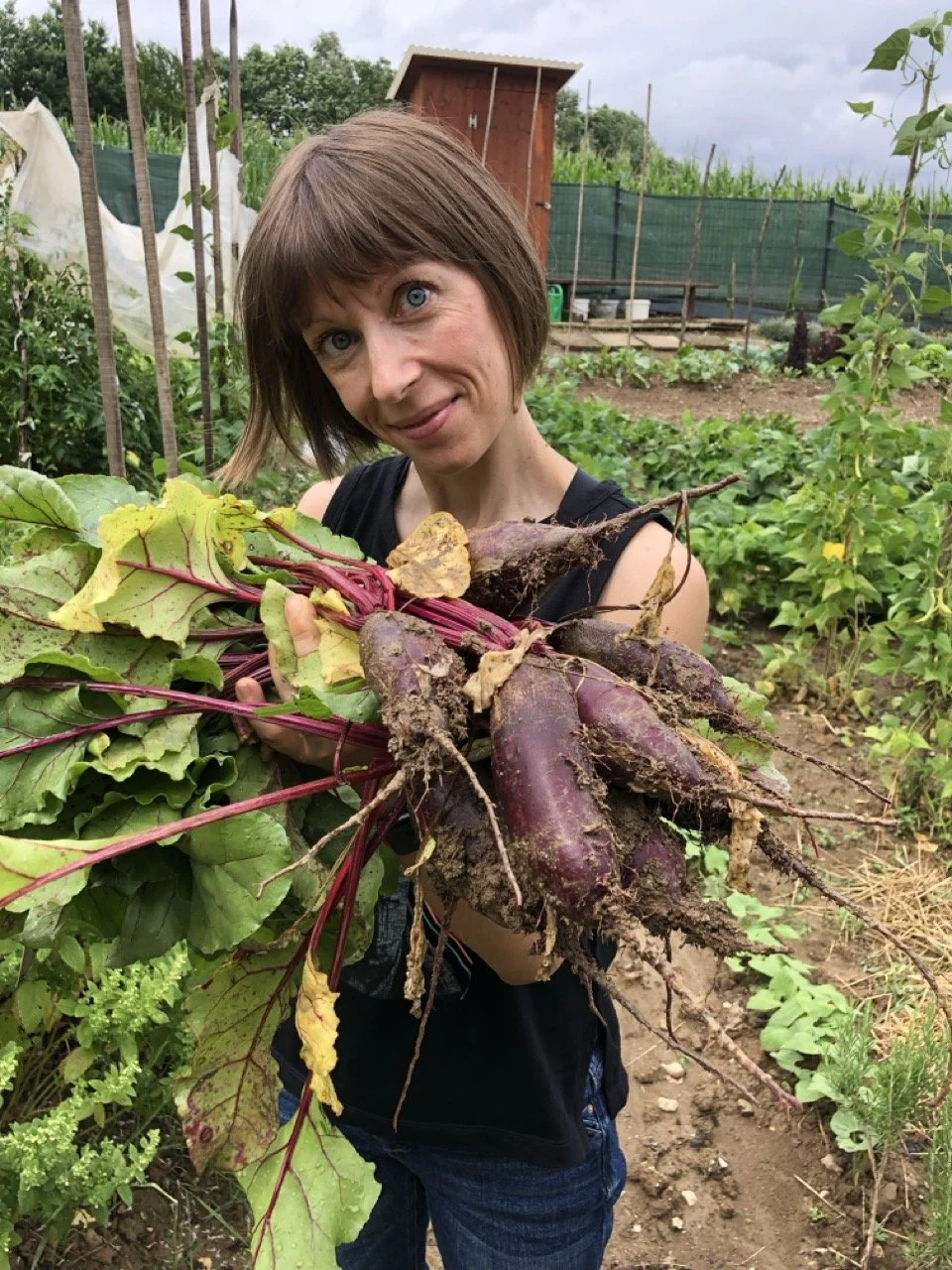 Diana holding freshly harvested beetroot in her mother-in-law's garden in Sevnica, Slovenia