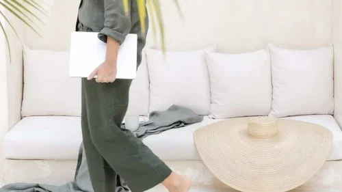 Woman walking with laptop