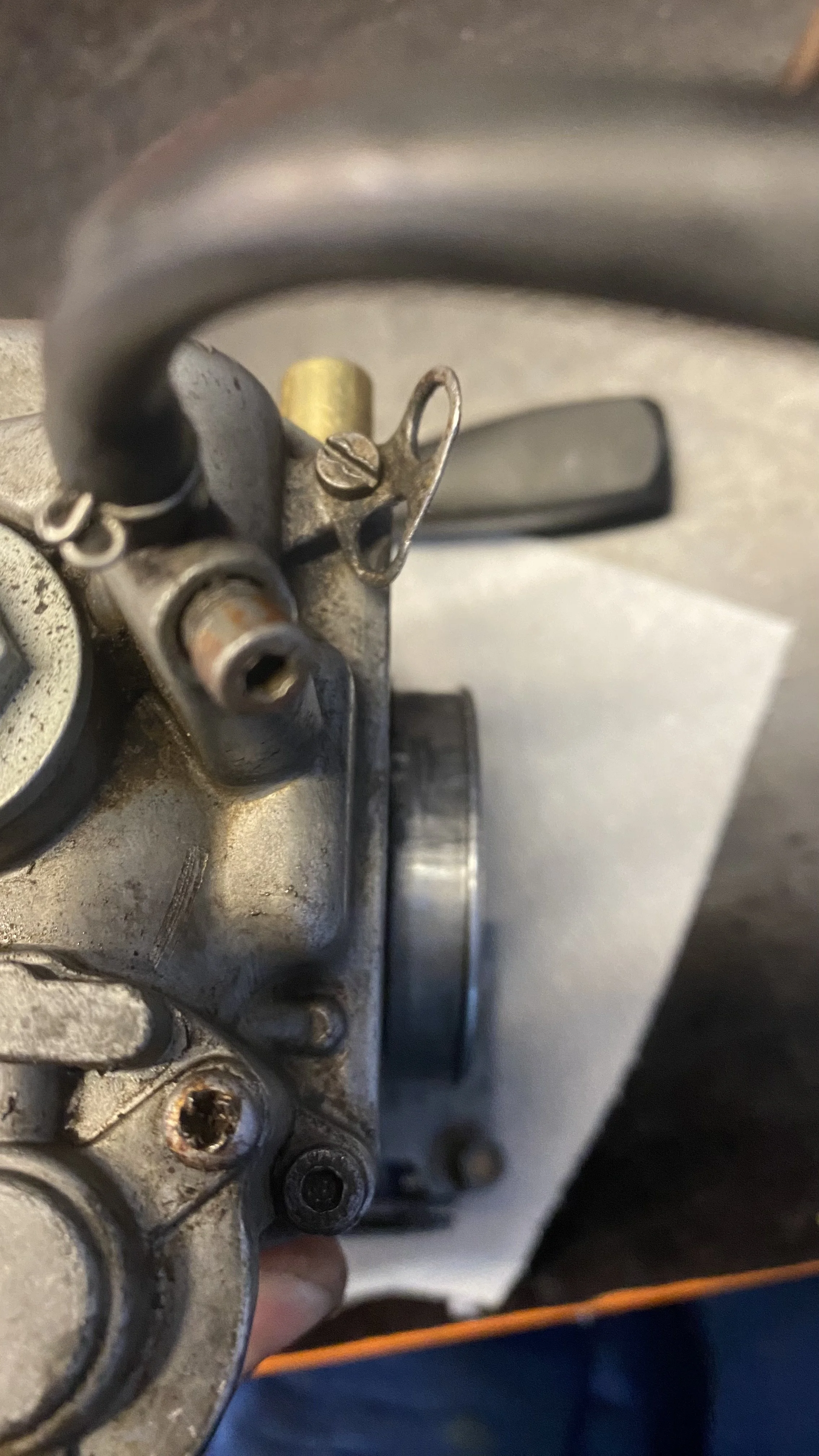 Close-up of a vintage metal firearm mechanism with screws and a trigger.