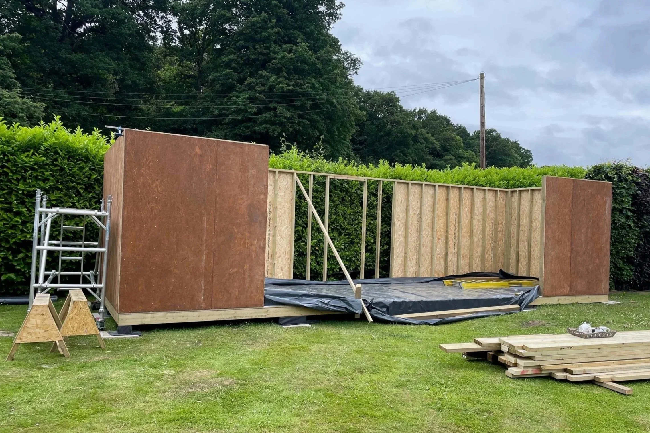 An image of the wooden structure of a summer house being built.